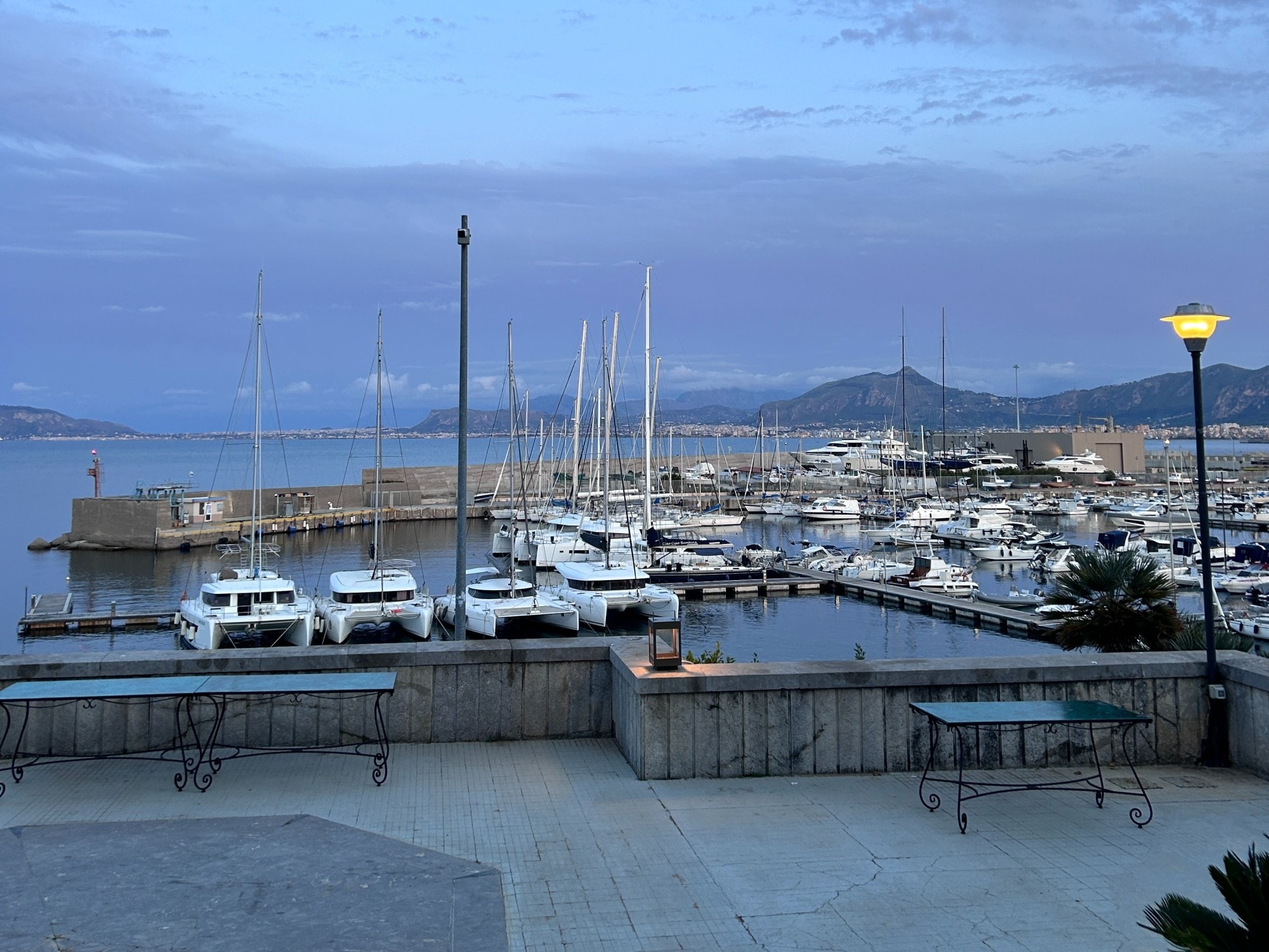 View of a marina with boats during the evening