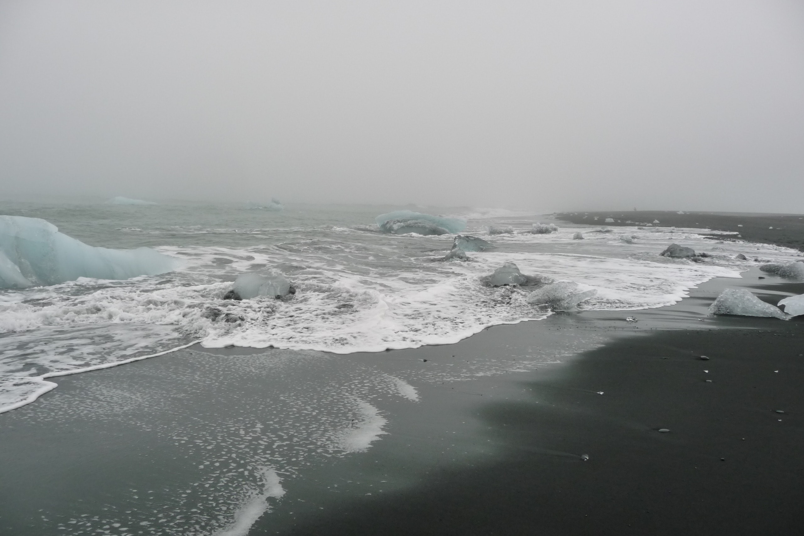 Diamond Beach's shoreline adorned with glistening icebergs.