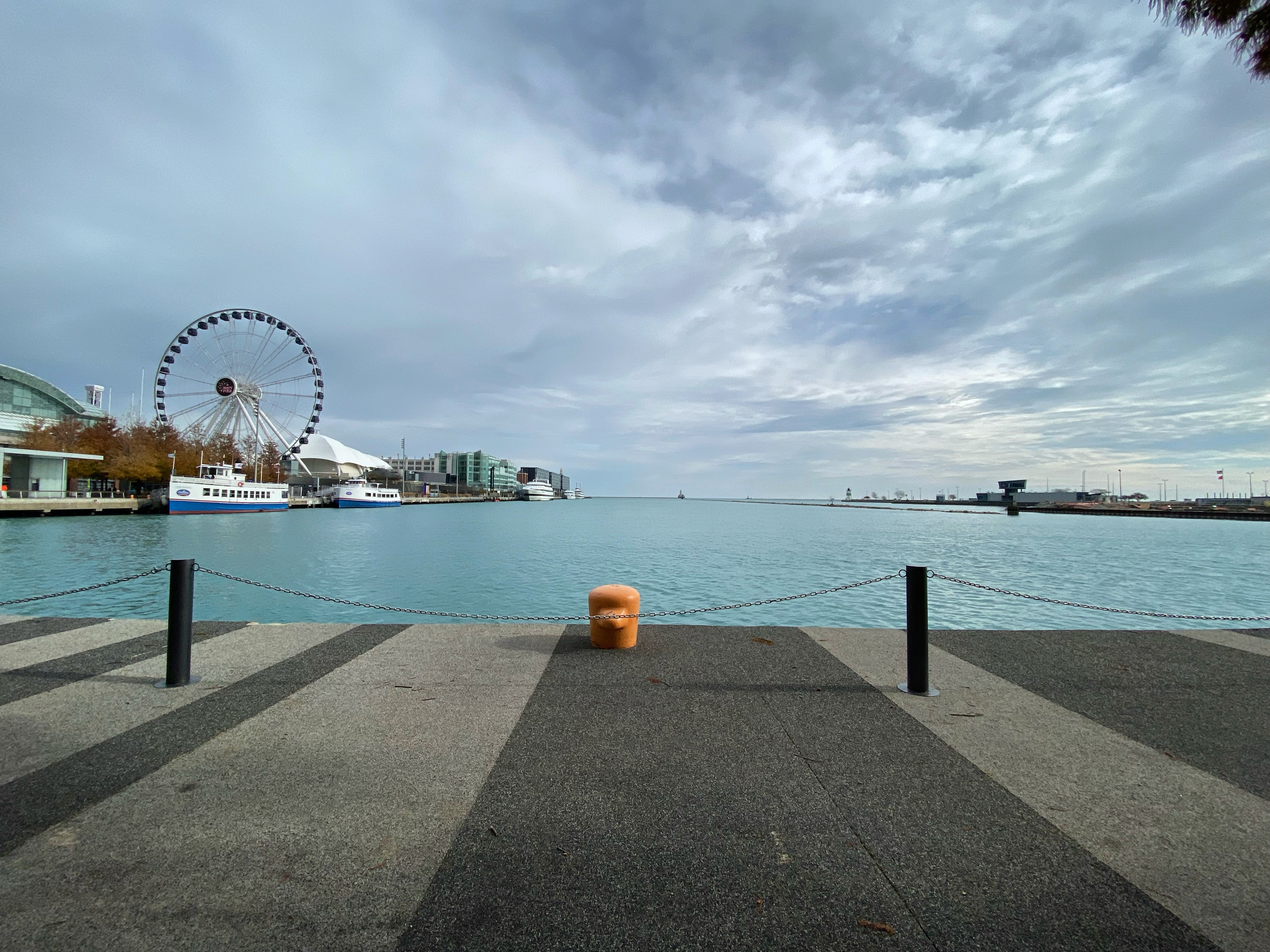 A view from Chicago's Navy Pier with the water and Ferris Wheel in sight. 