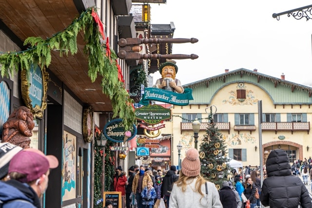 A daytime scene of a bustling outdoor, holiday shopping center.