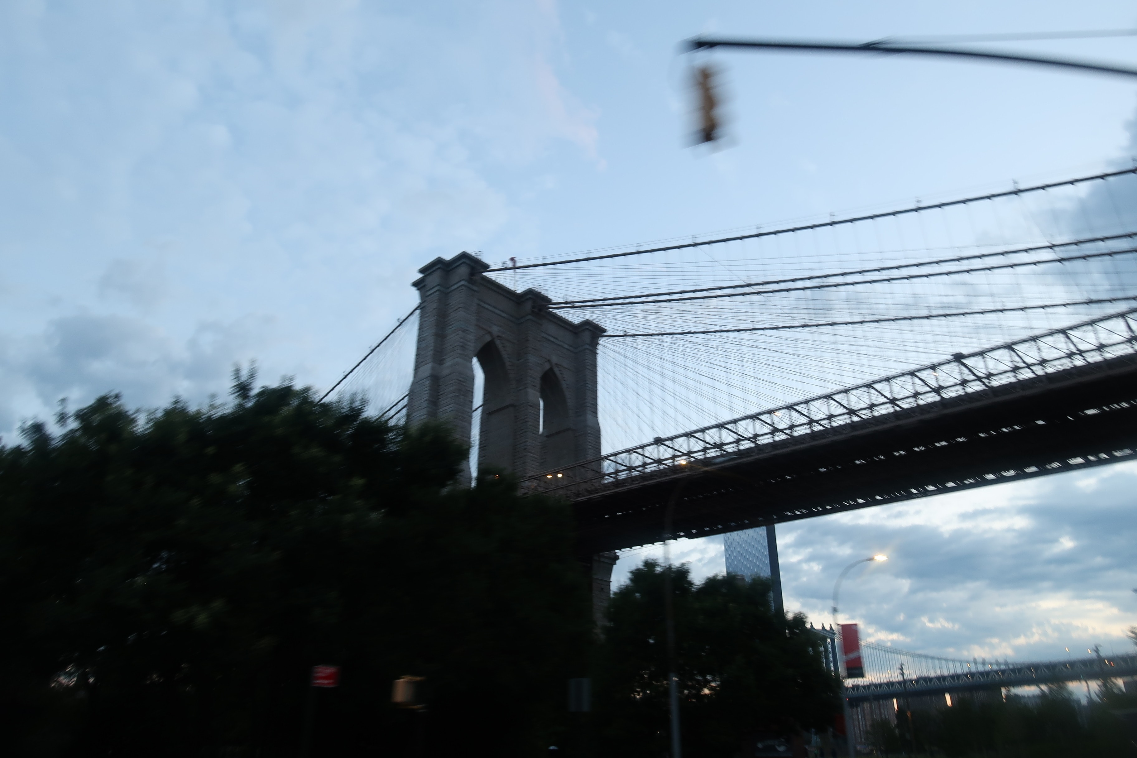 A view of the Brooklyn Bridge from a car window.