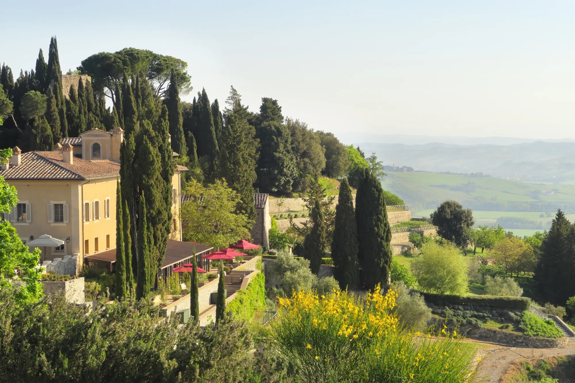 a yellow hillside estate overlooking the rolling countryside