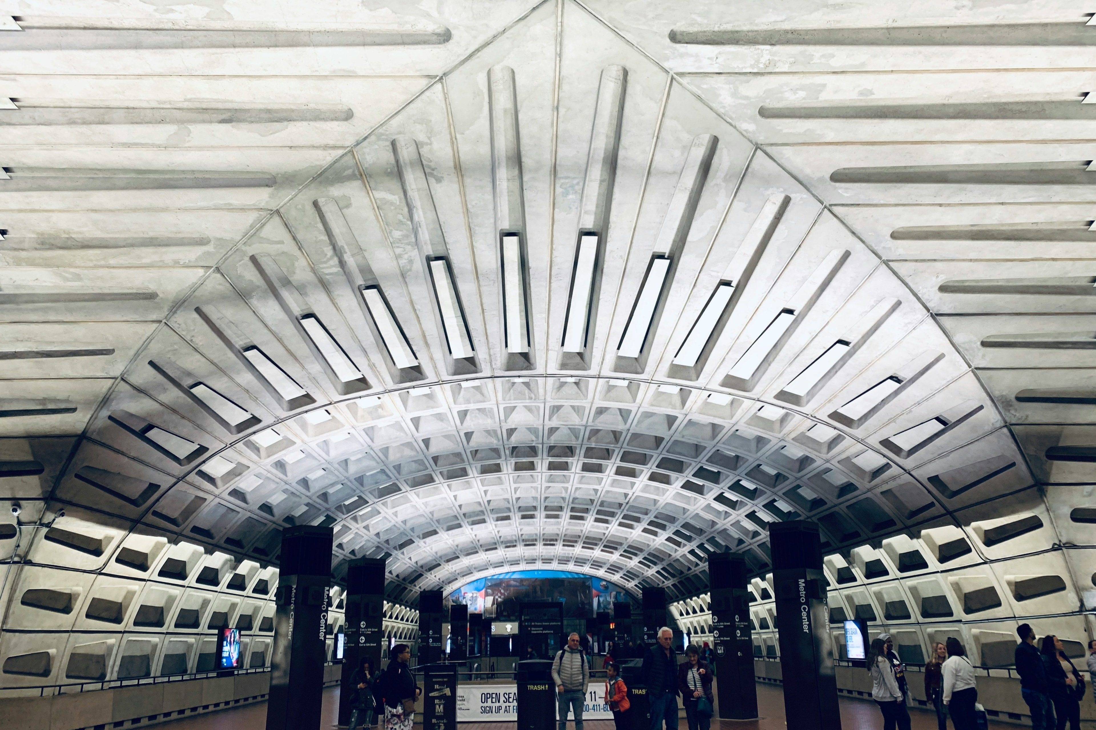 A picture of people walking at a metro station.