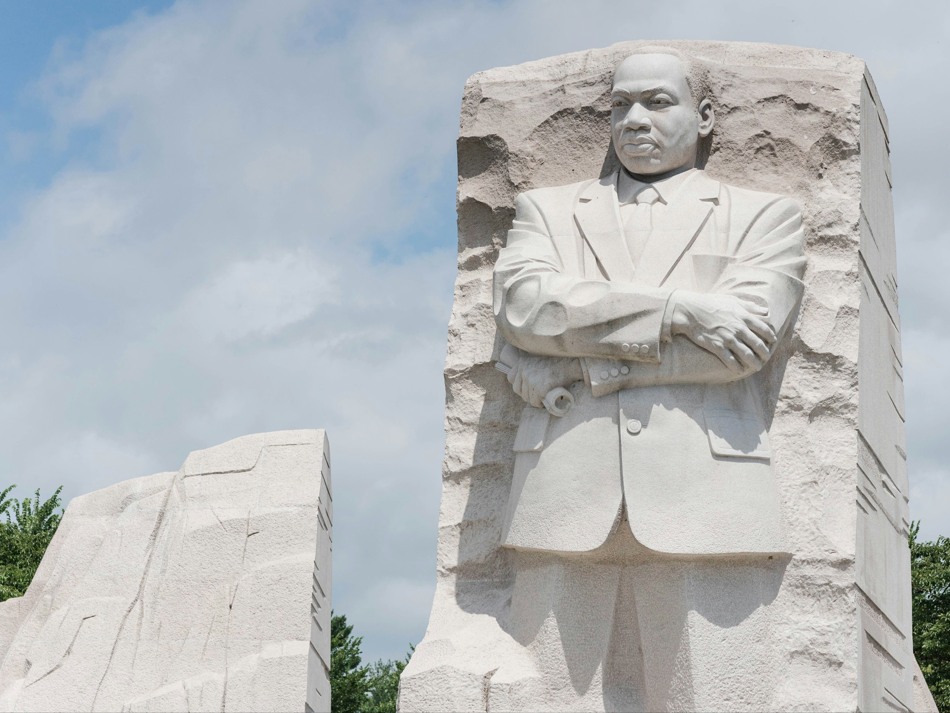 A white colored statue of Martin Luther King, Jr.,  during the daytime.