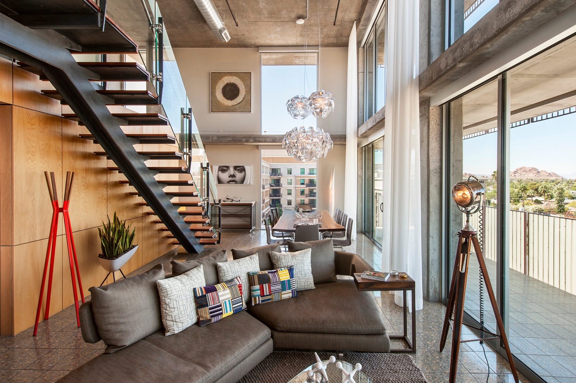 a colorful loft with eclectic artwork and a trio of globe-shaped chandeliers