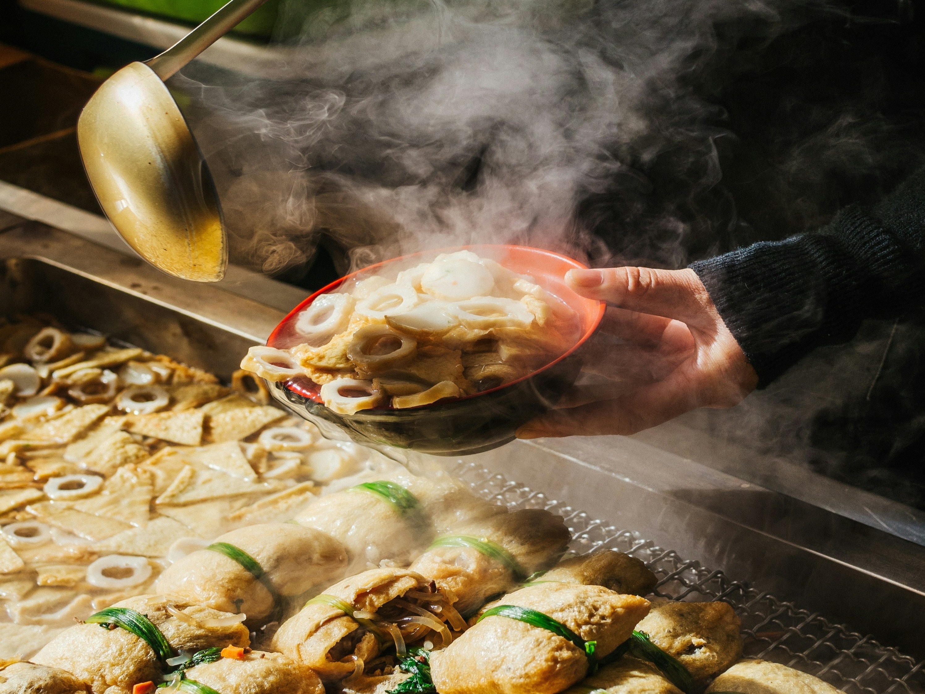 A picture of a person holding a bowl filled with food.