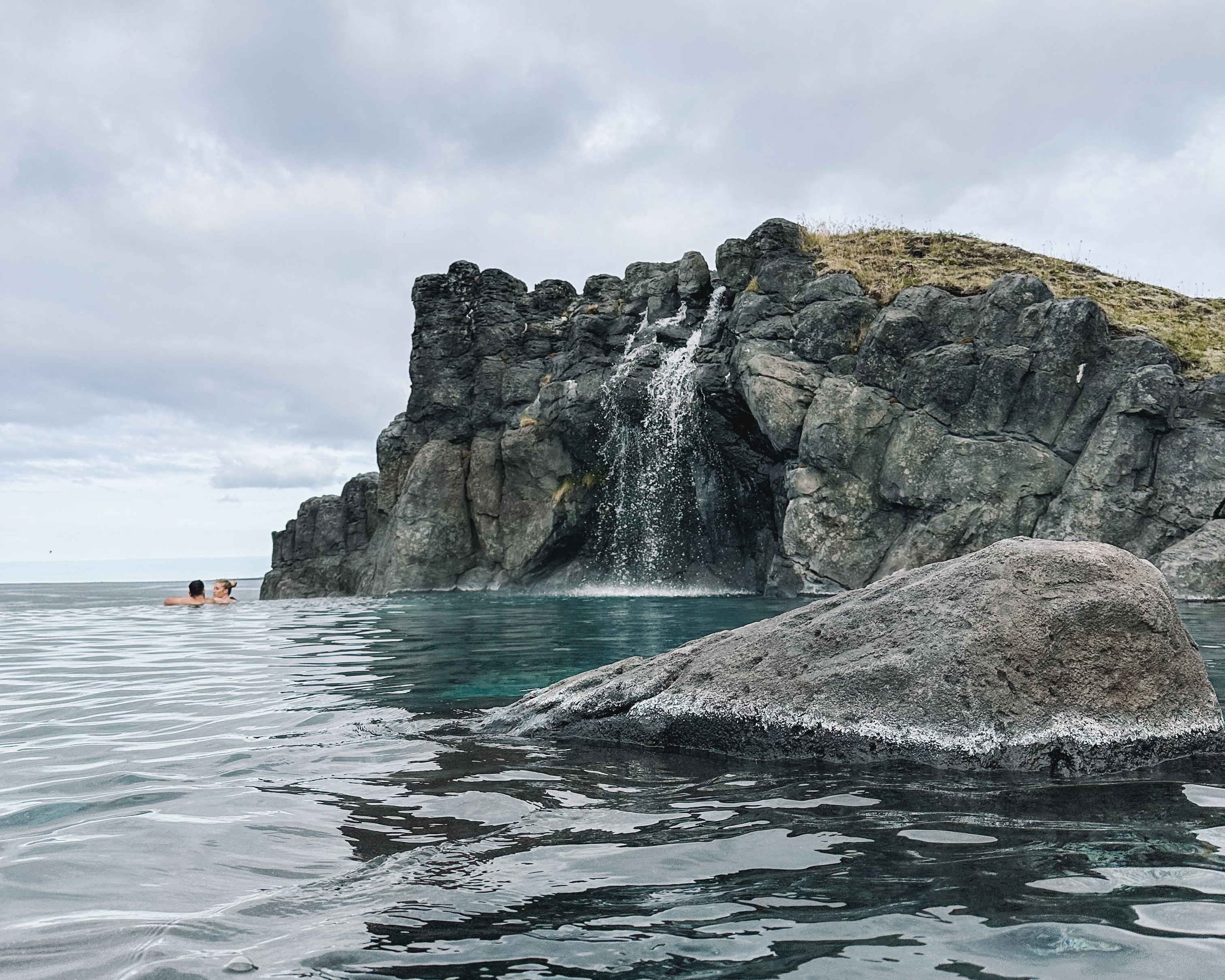 Rock structures in a body of water during the daytime