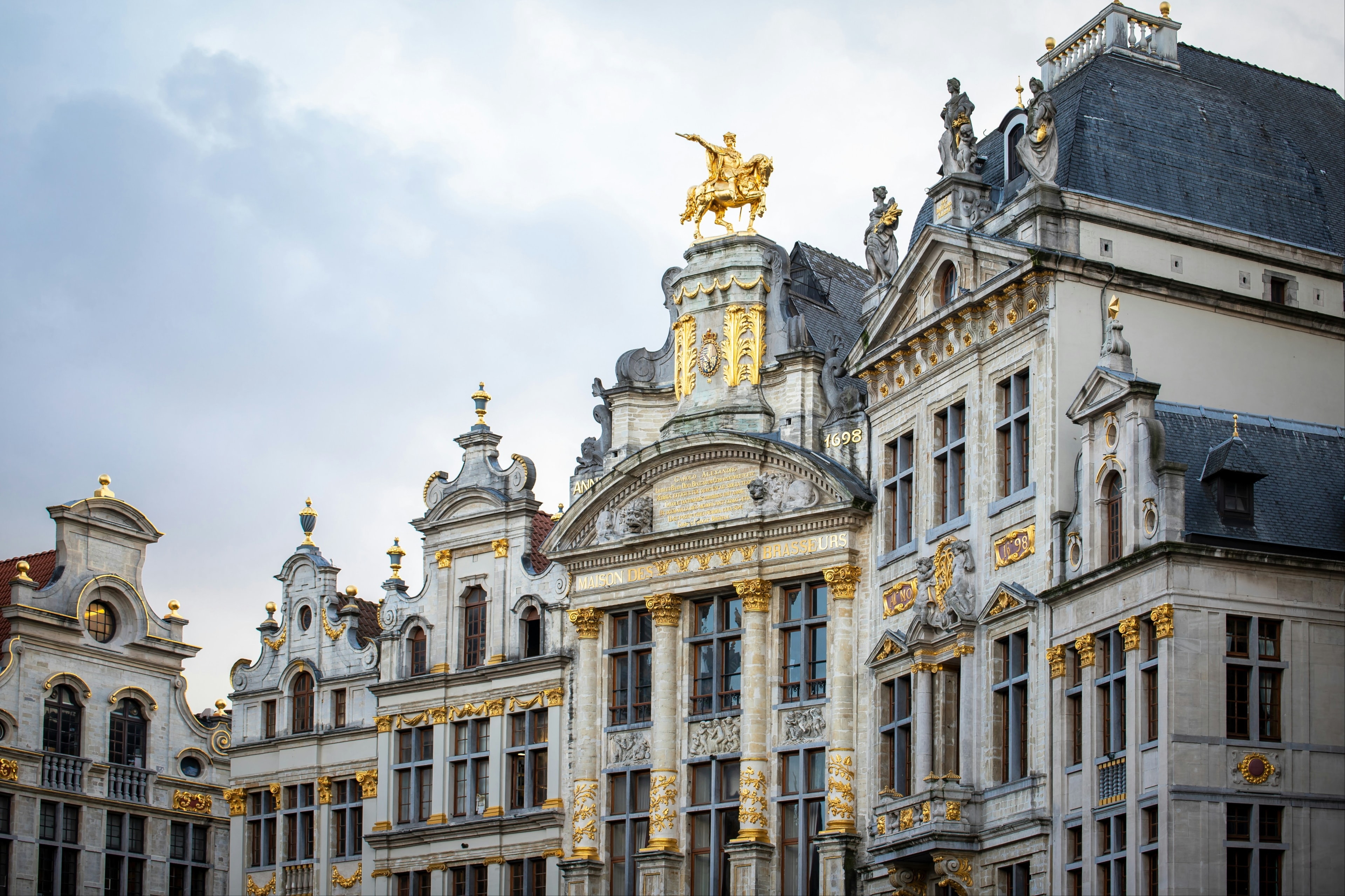 A grand white building with gold trim and detailing. 