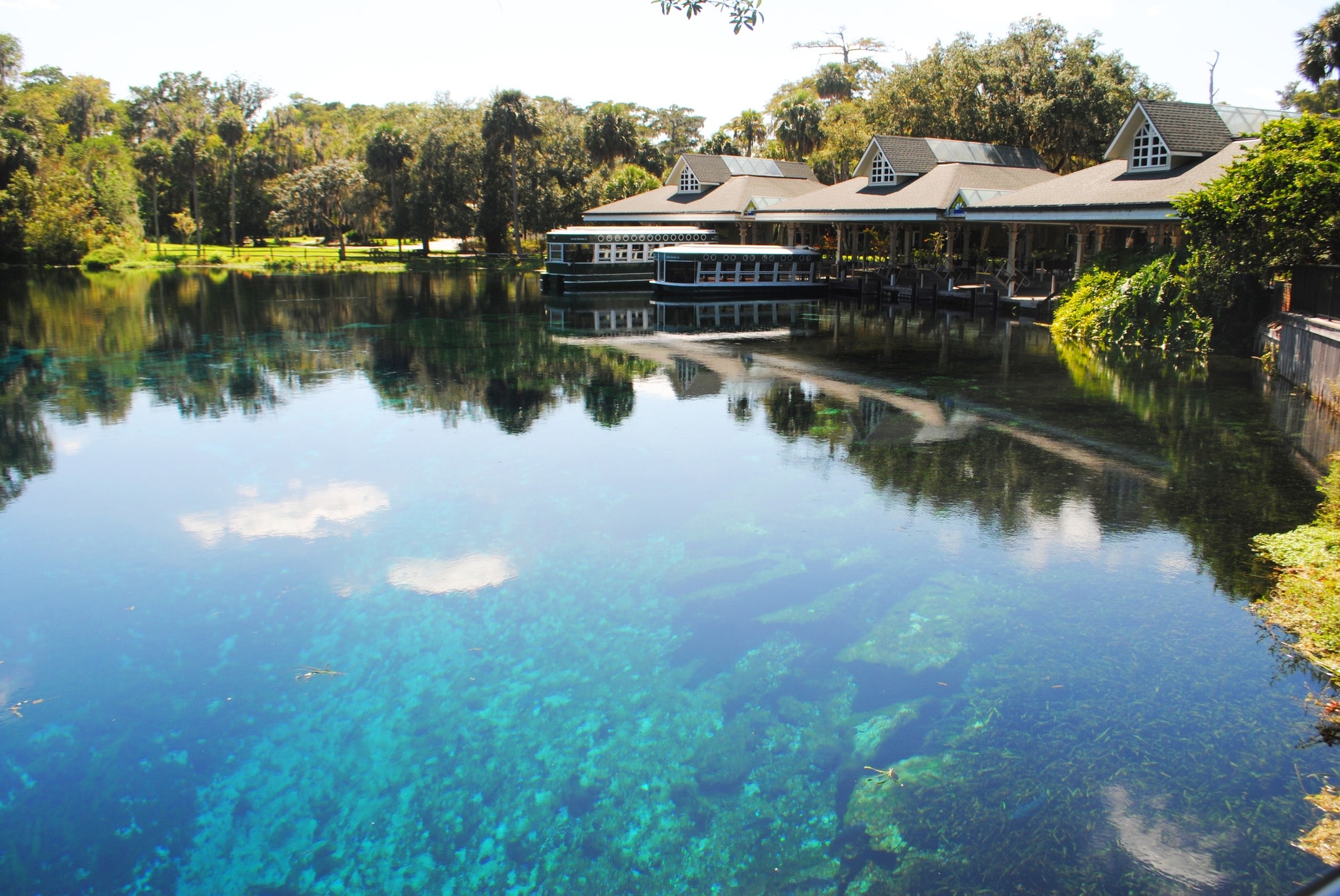 A blue body of water with a building on the other side during daytime