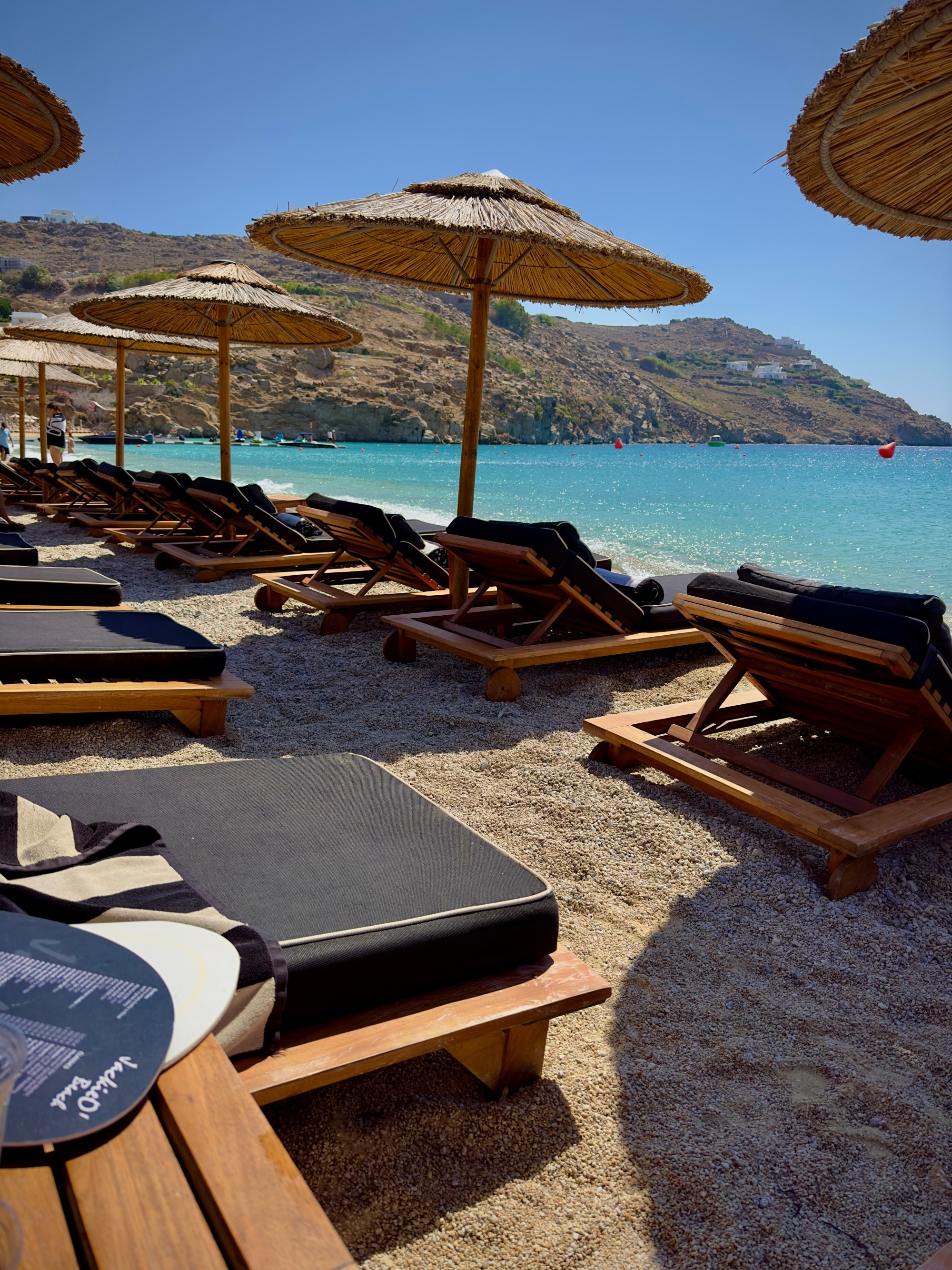 A group of beach chairs on the beach during the daytime