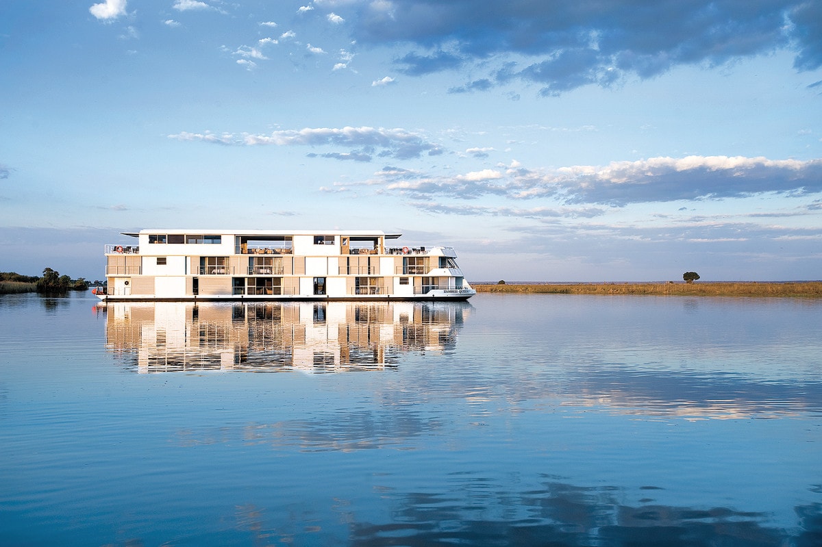 a white ship with a geometric design on a body of water