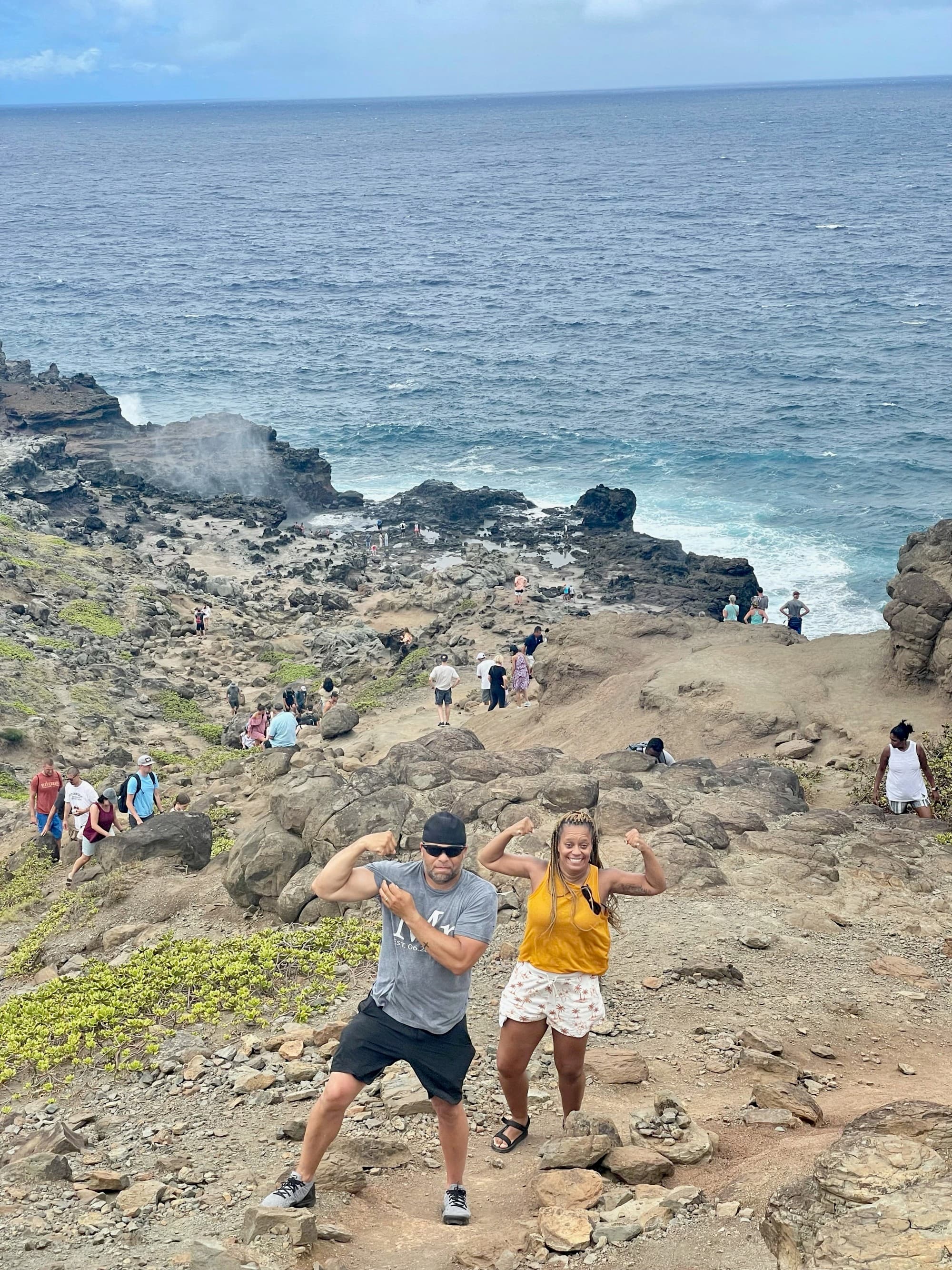 Shana poses on the rocky steep shores of island with a man