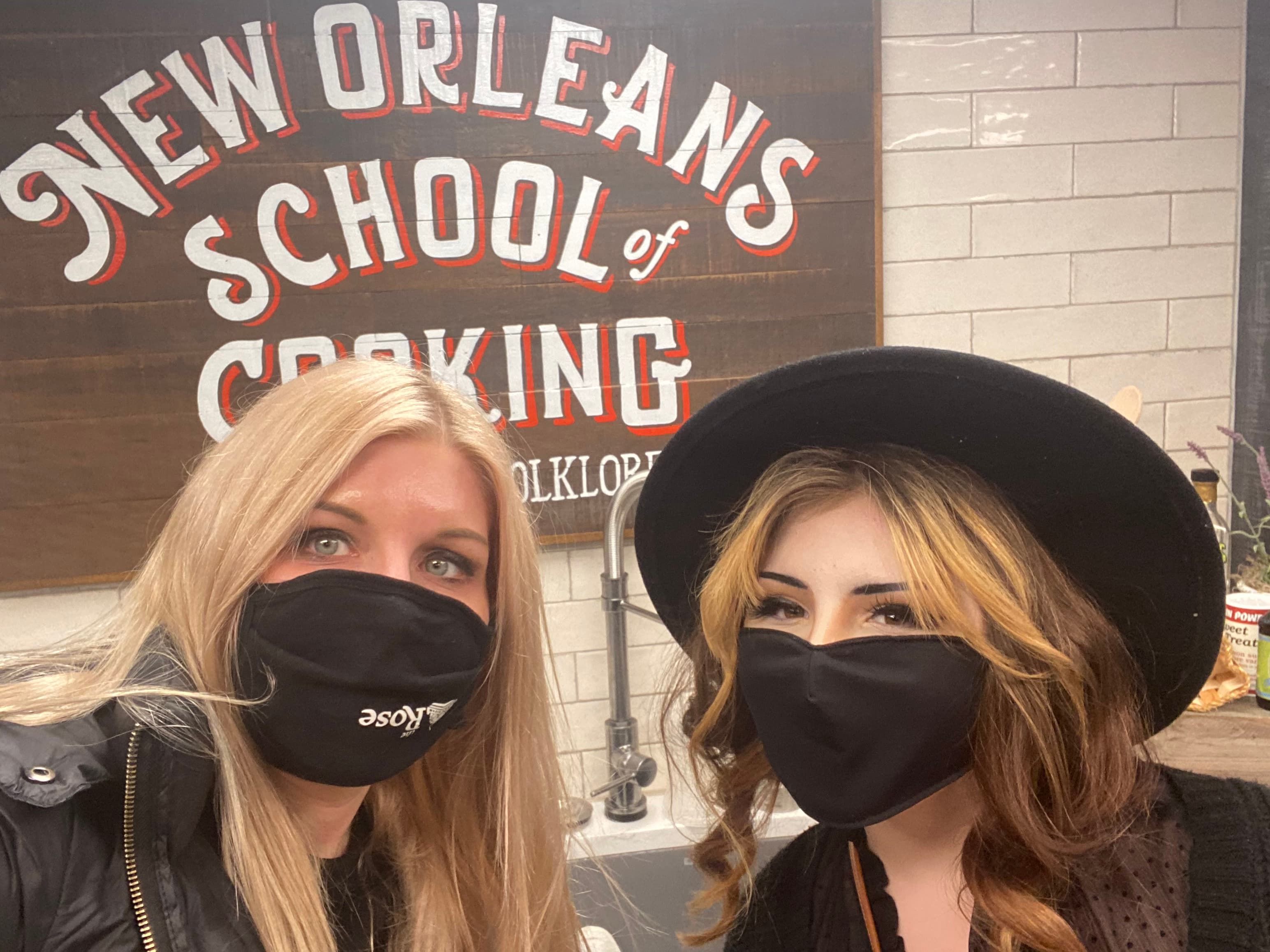 Two women posing in mask