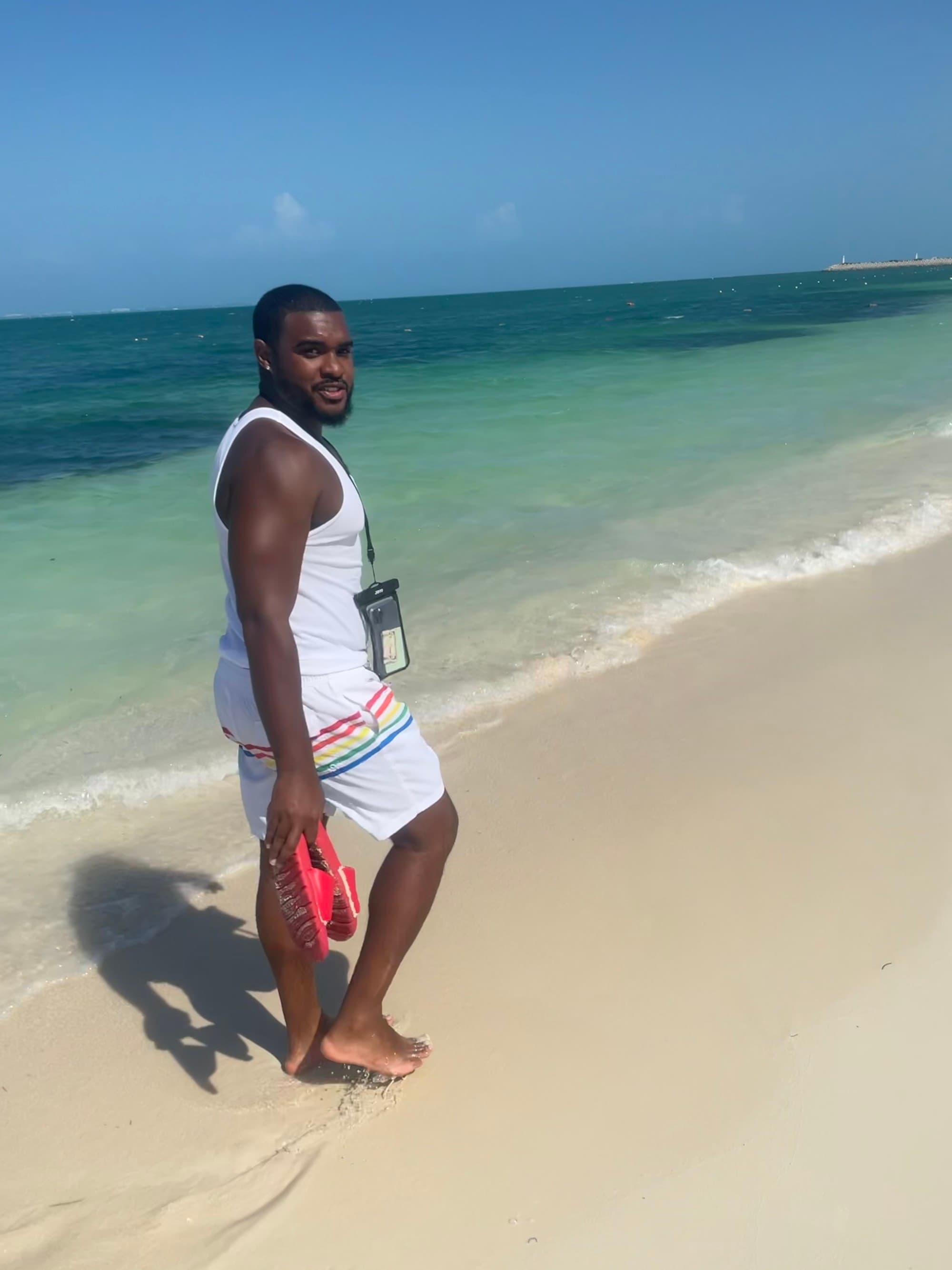 Travel advisor walking on a beach.