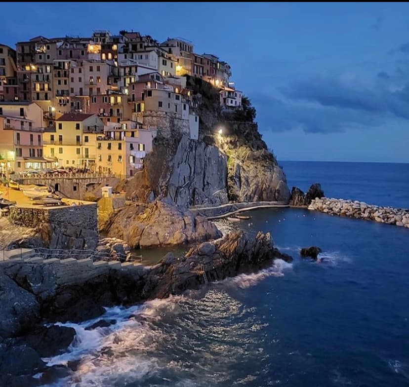 coastal cliffside island town lit up at night