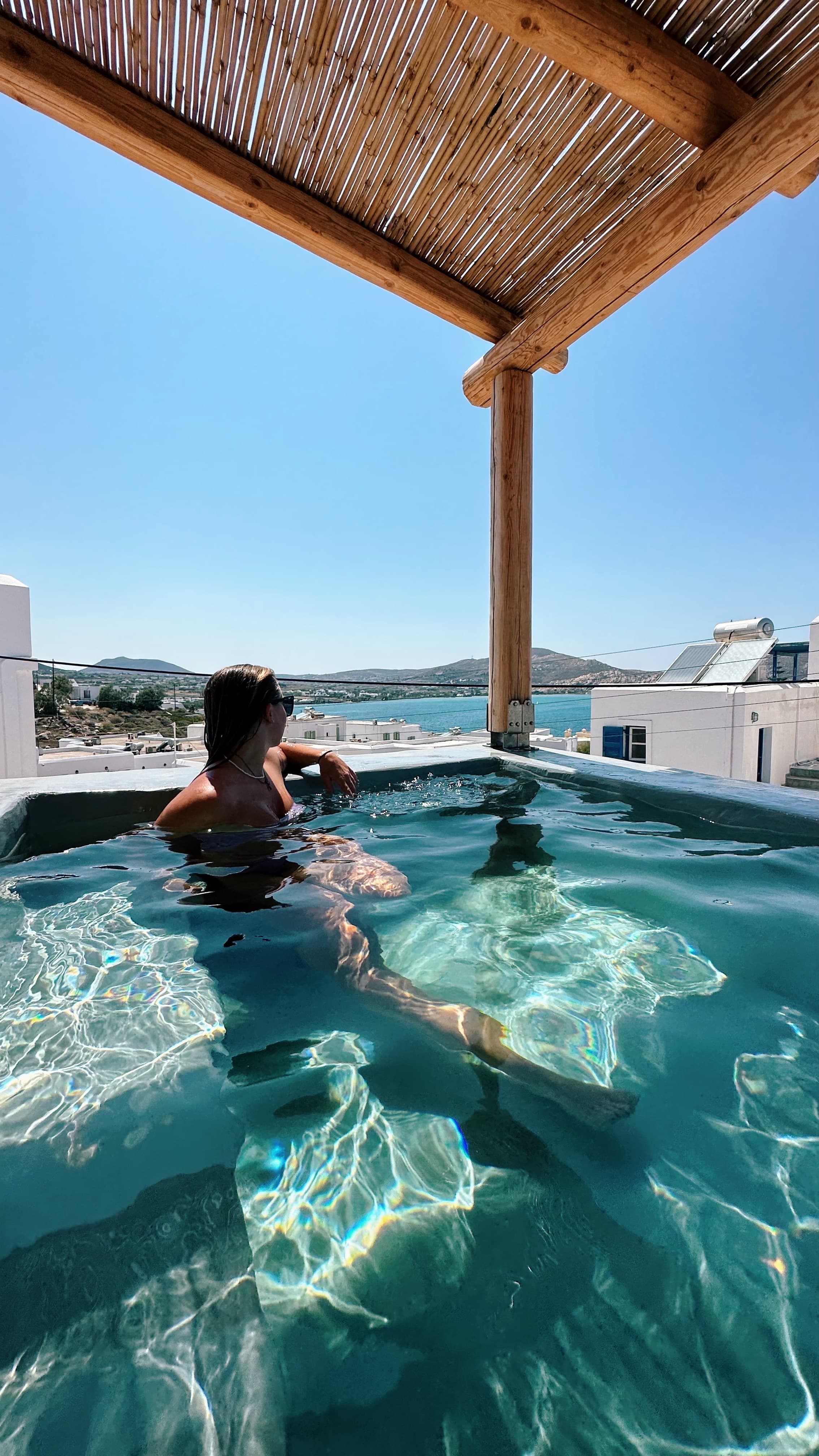 Travel advisor posing in a pool