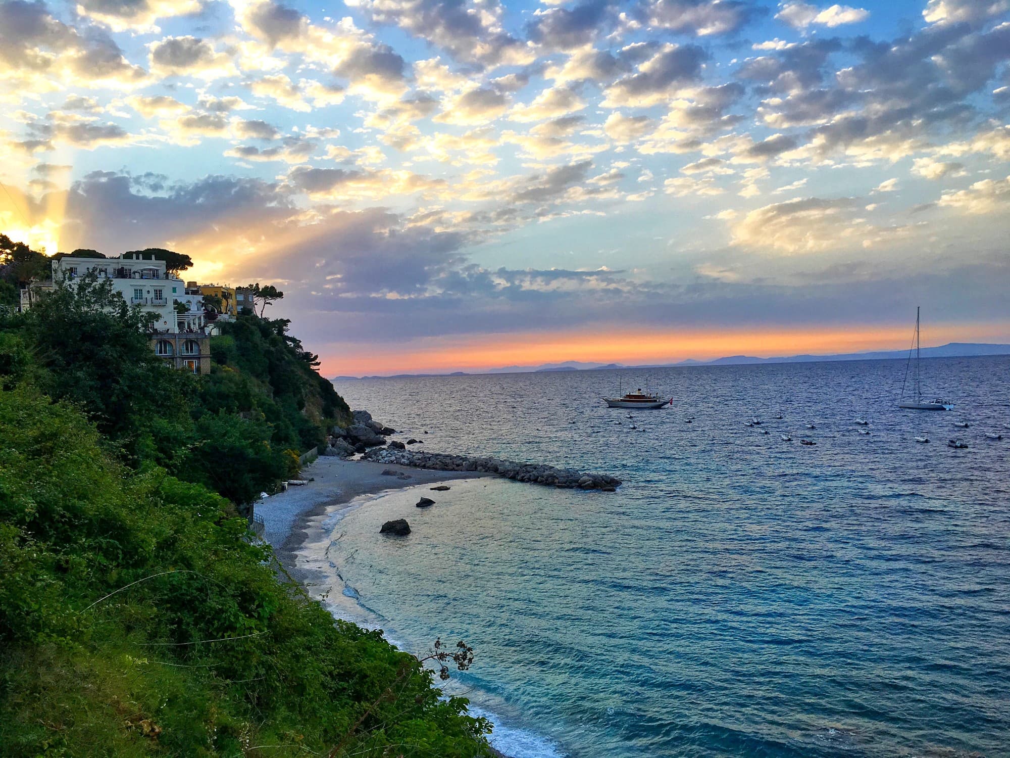 An ocean with green shore.