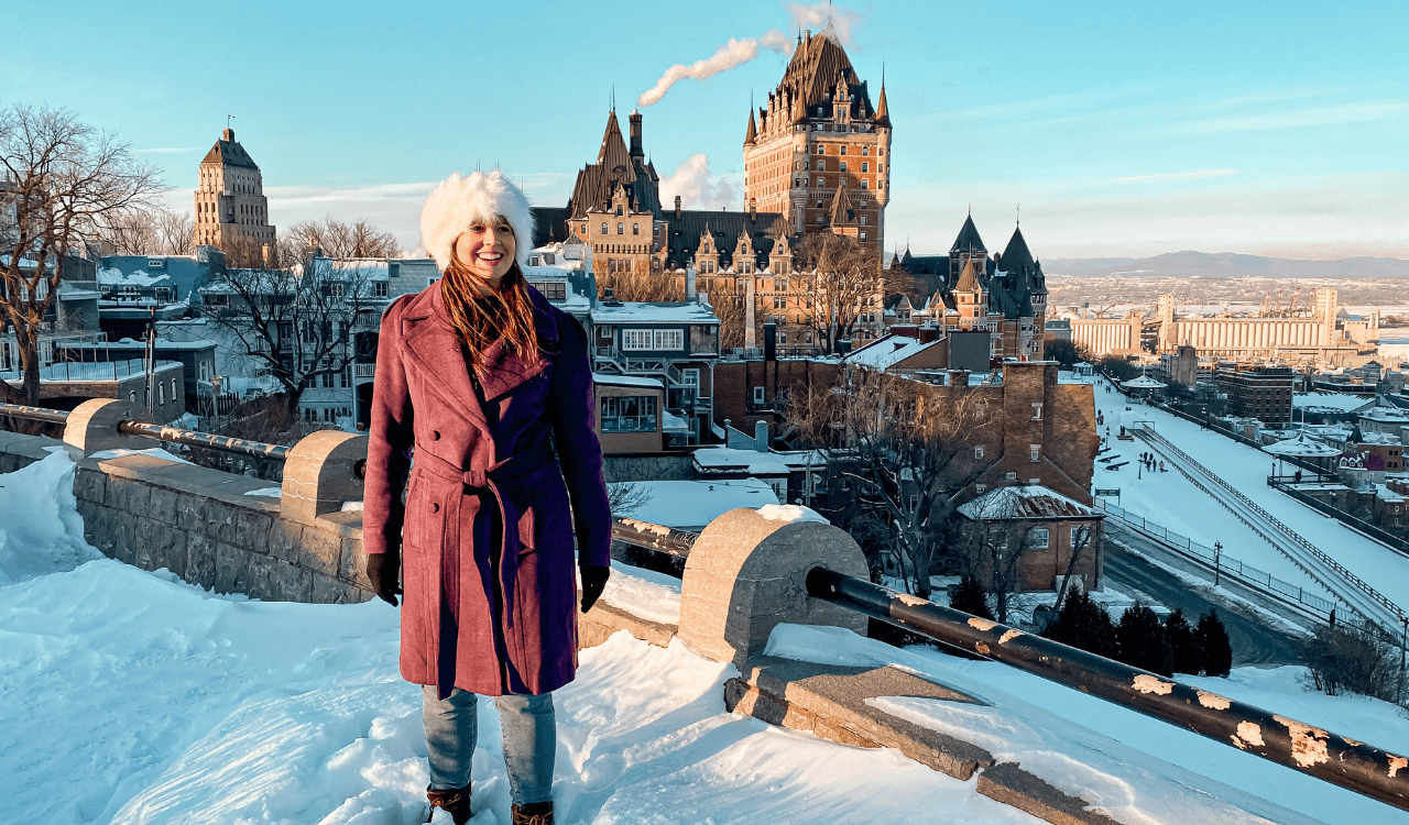 Travel advisor posing in a snow-covered valley
