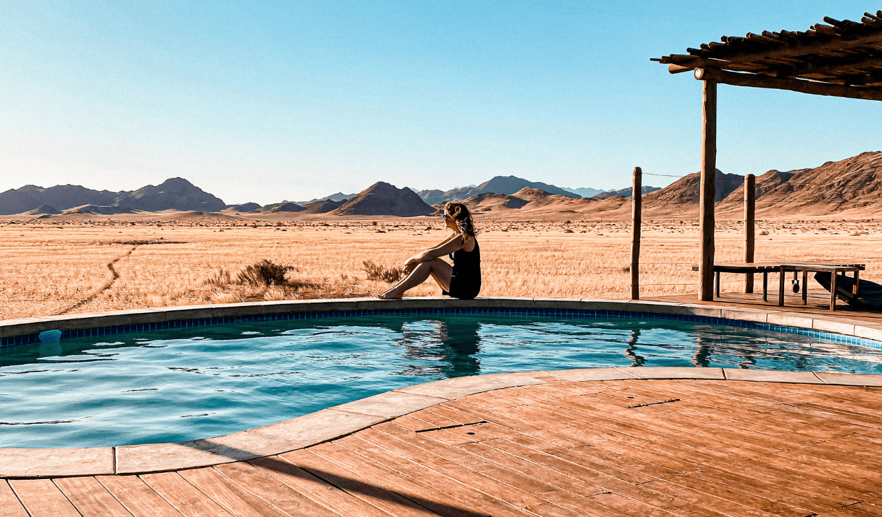 Travel advisor posing beside a pool