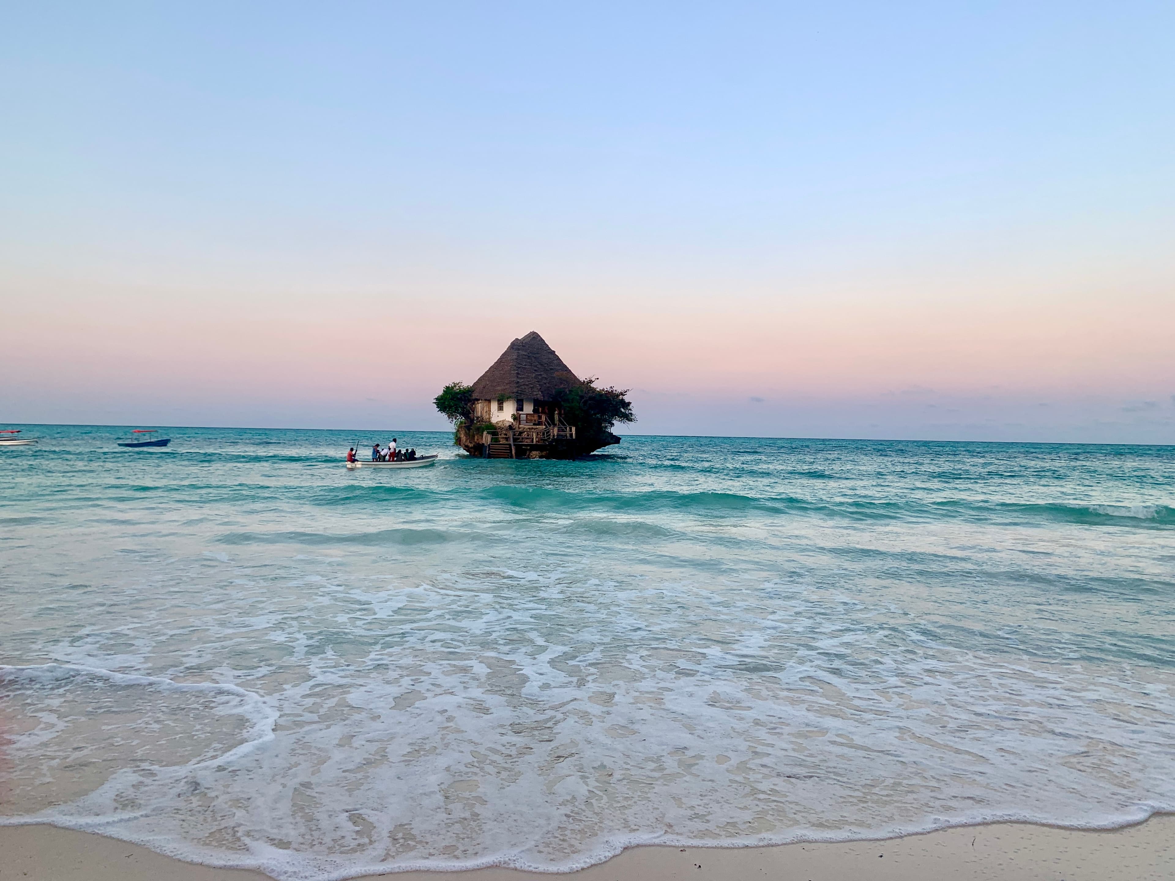 Small boat carrying people to the water hut