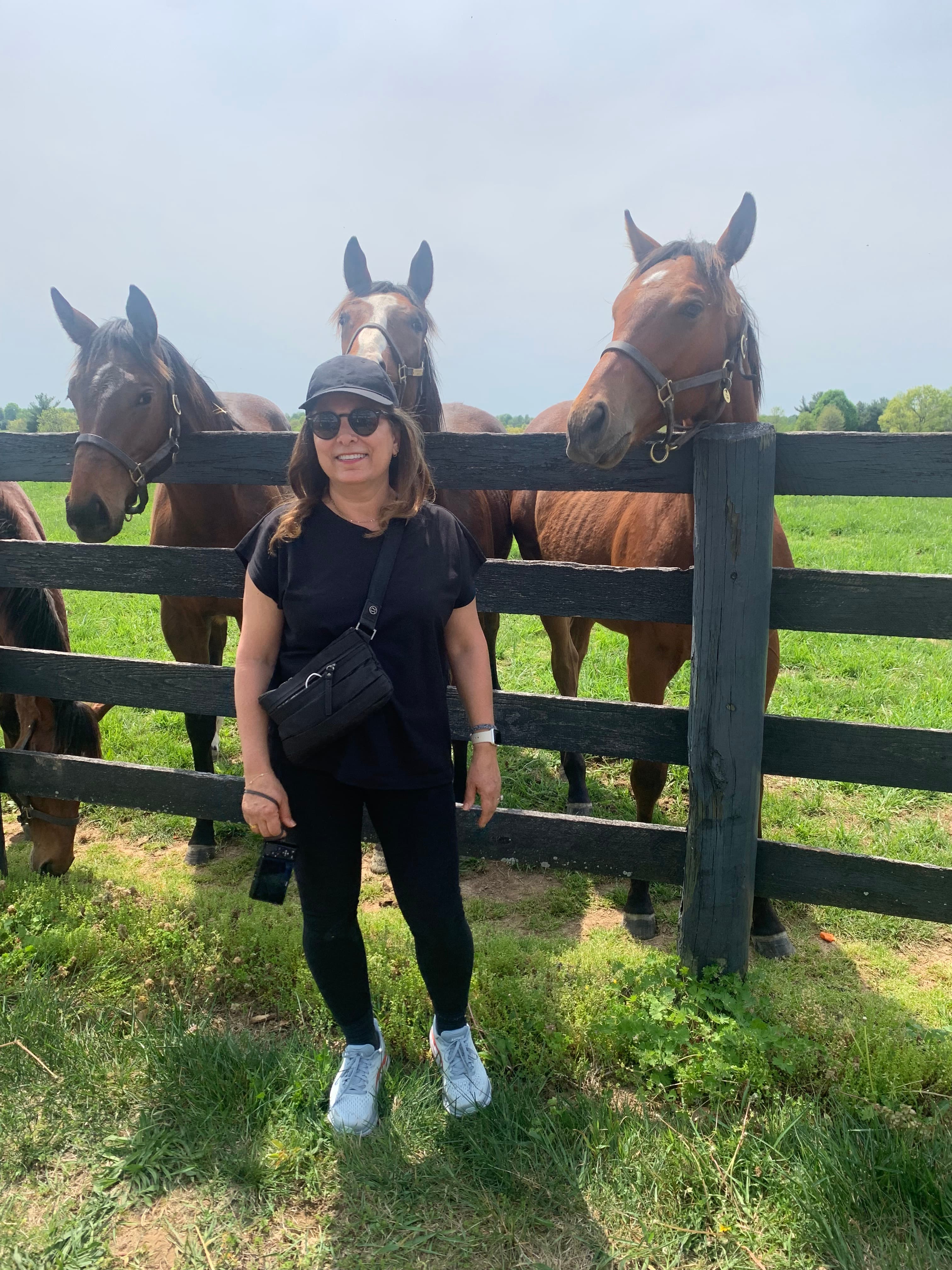 Travel advisor posing with horses