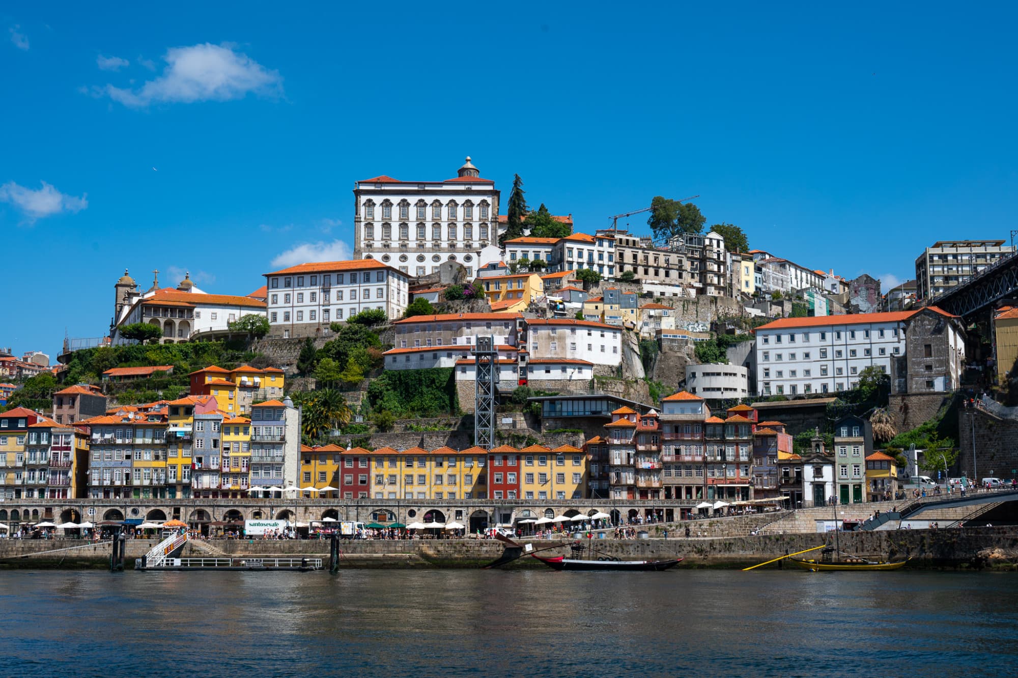 Buildings on mountain with water body in the front.