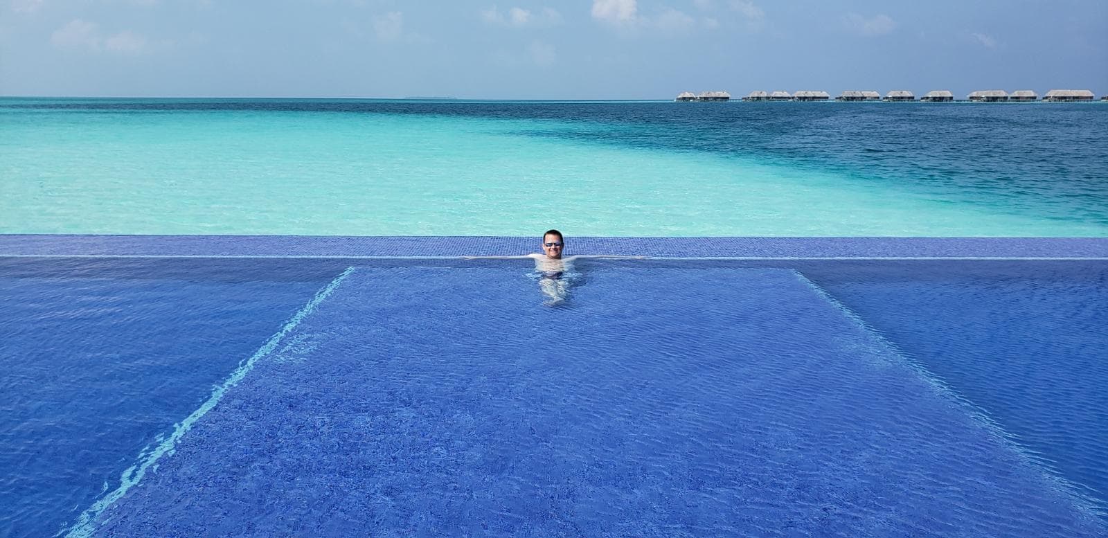man in pool in the maldives