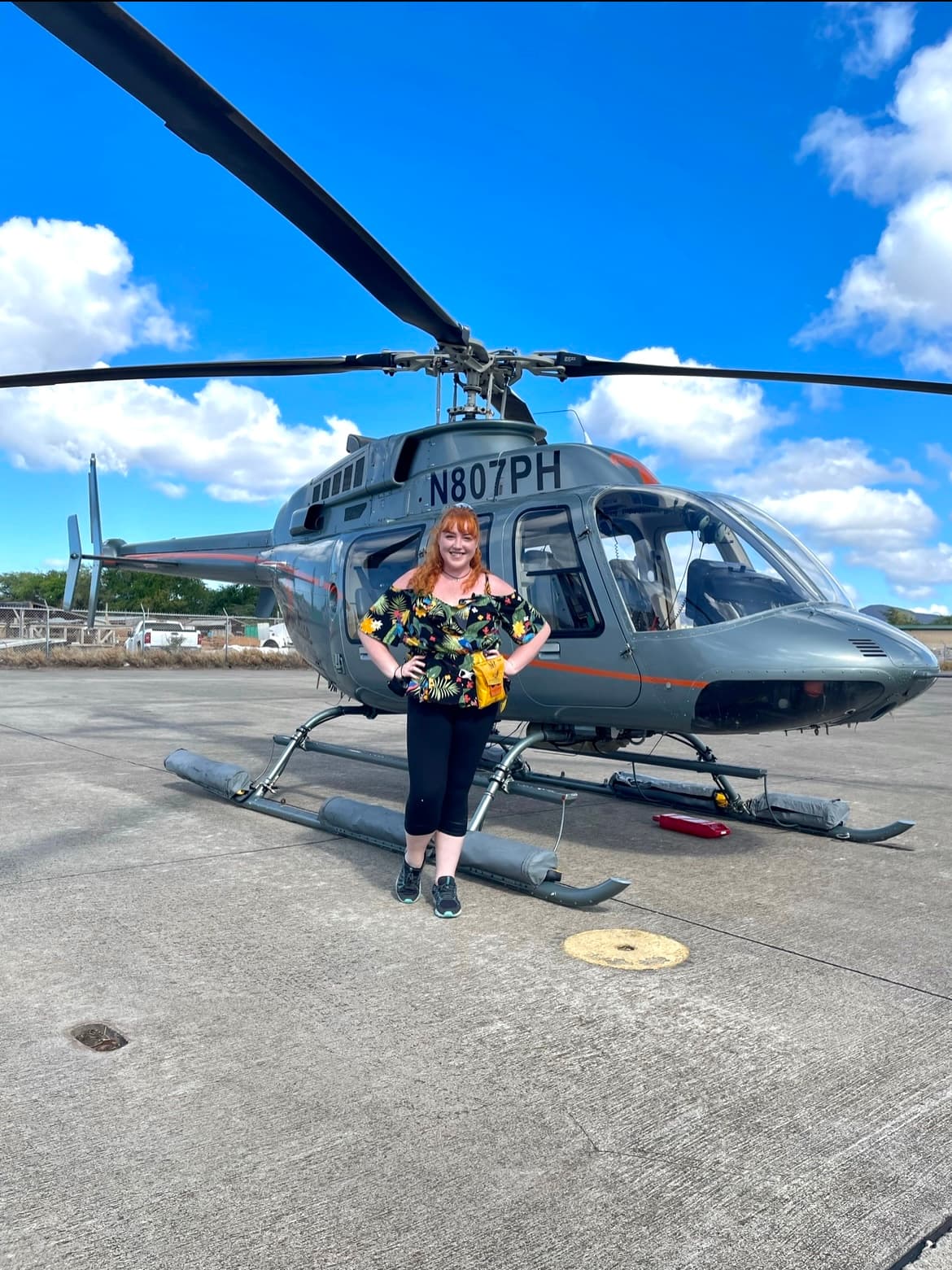 standing by a helicopter