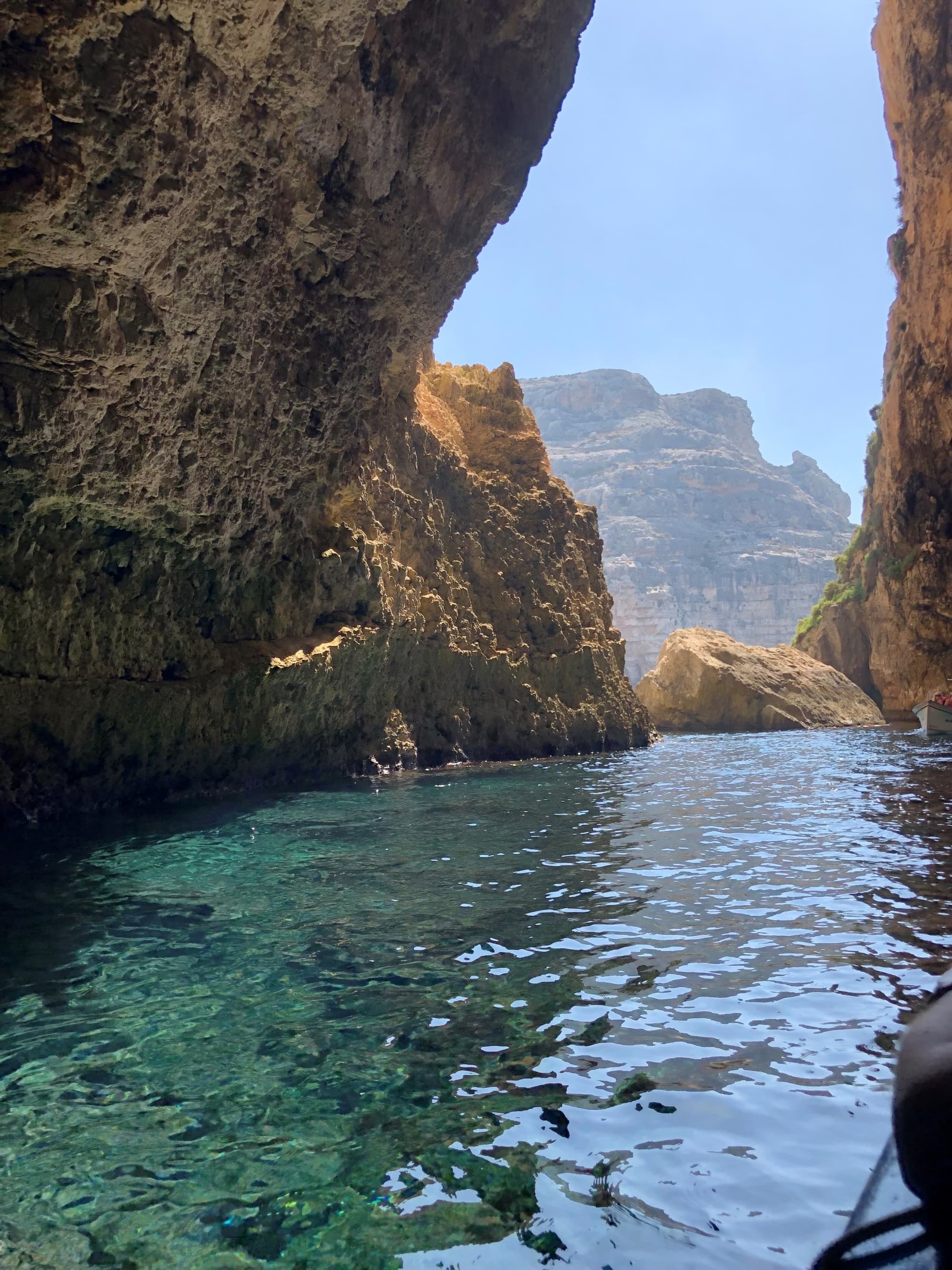 Water body between rocky hills.