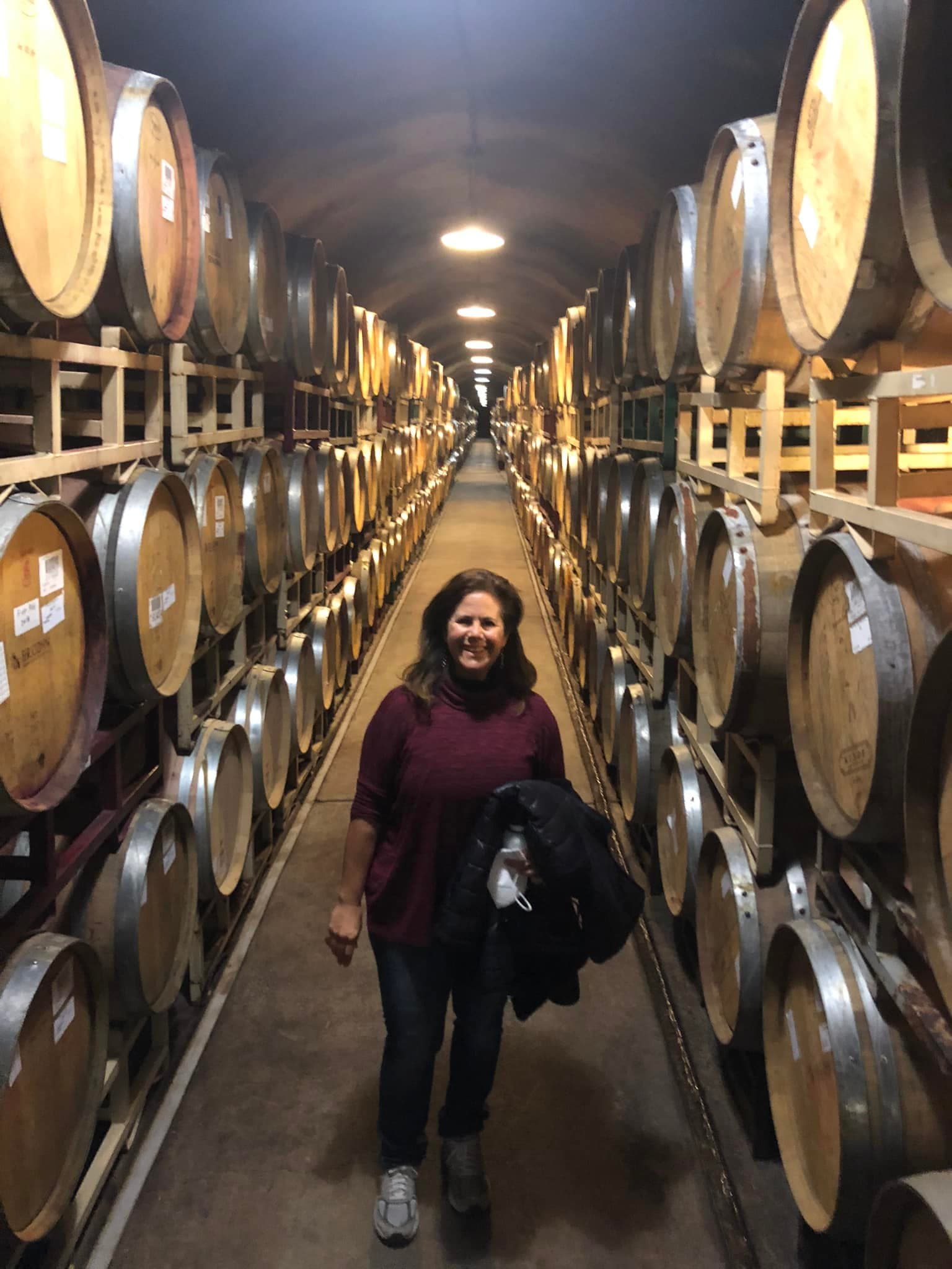 Travel advisor in a gallery with barrels.