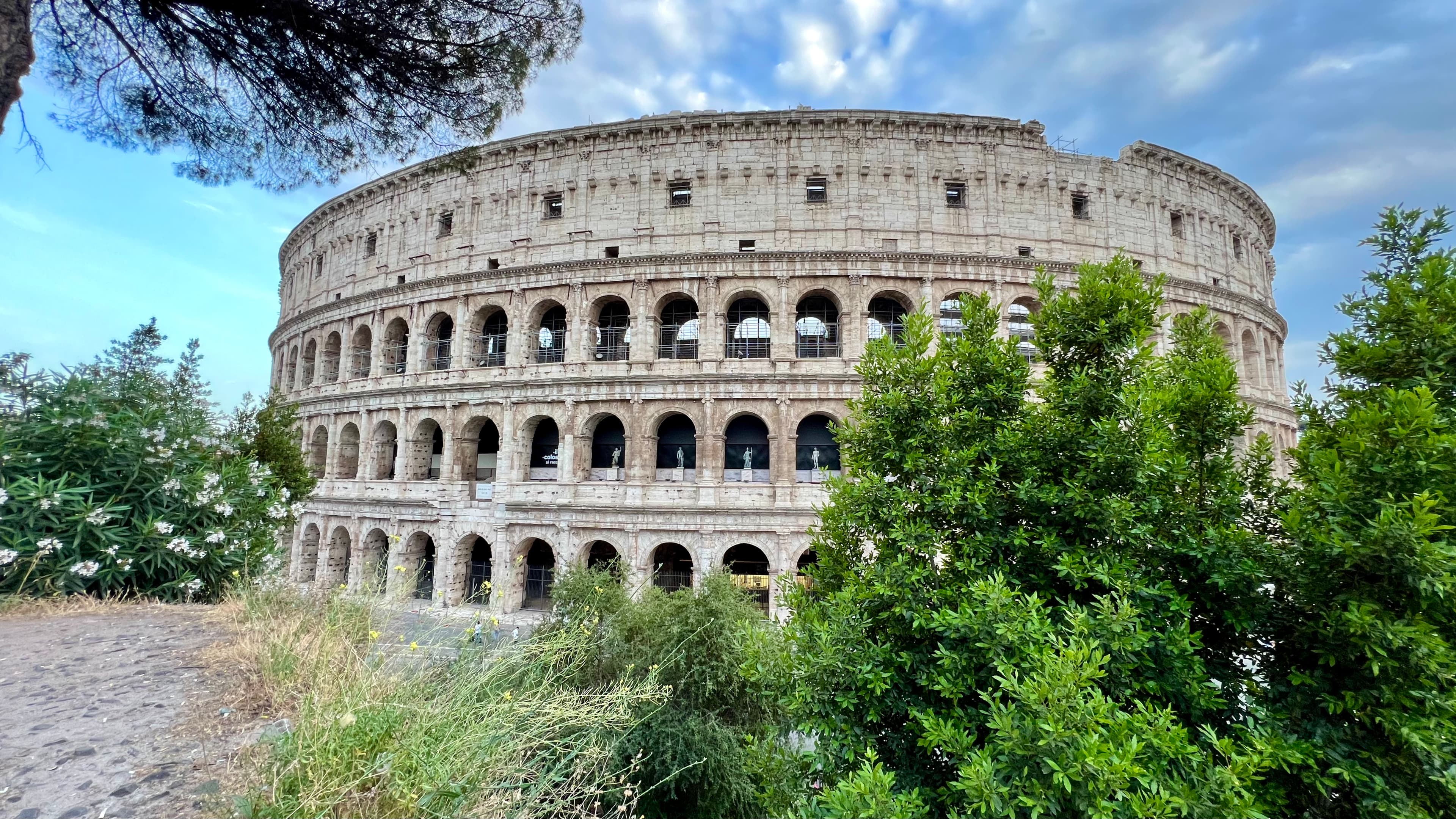 A Colosseum surrounded by green trees