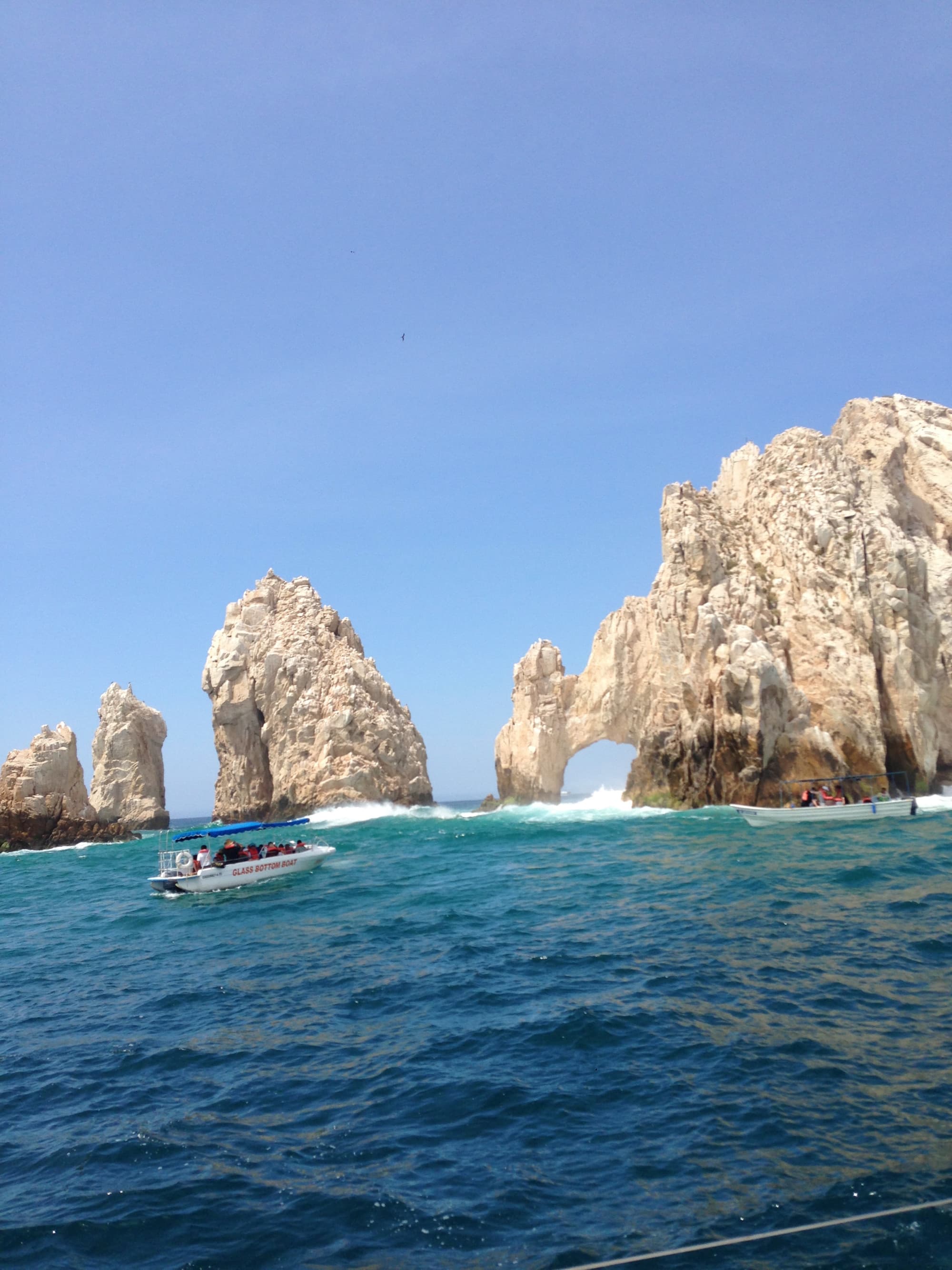 Water body with cliffs and a boat.