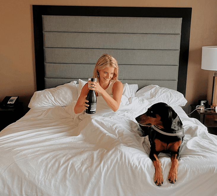 Picture of Sara in bed with dog