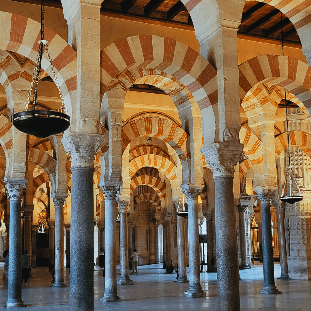 Inside architecture of a building with high arches and striped walls