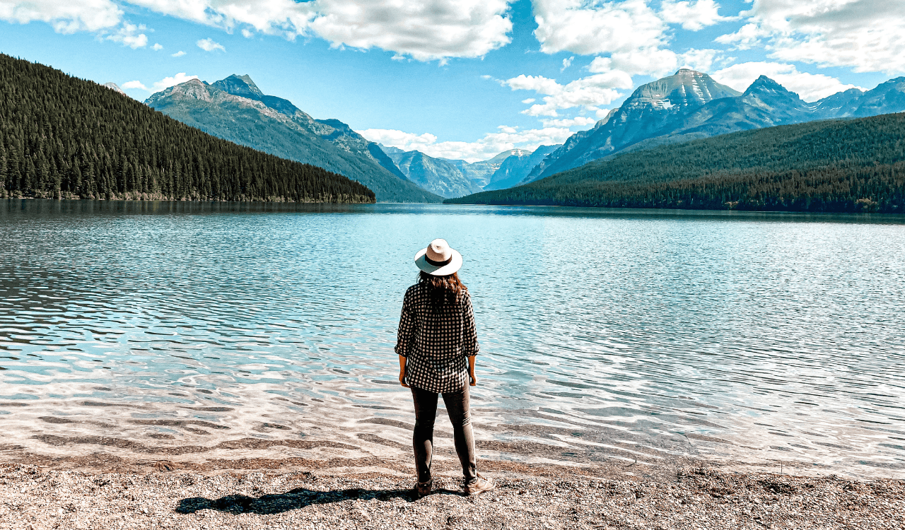 Travel advisor posing beside a lake