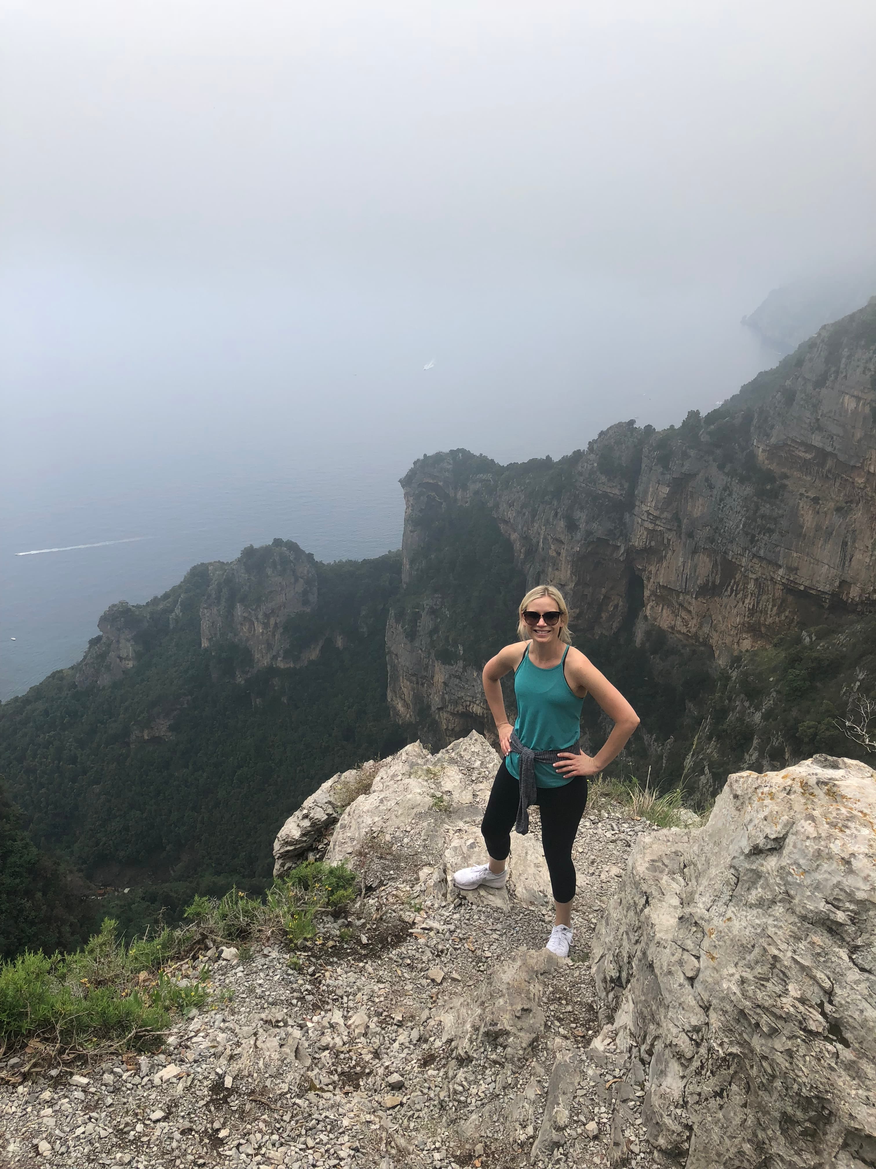 Travel advisor posing in a valley