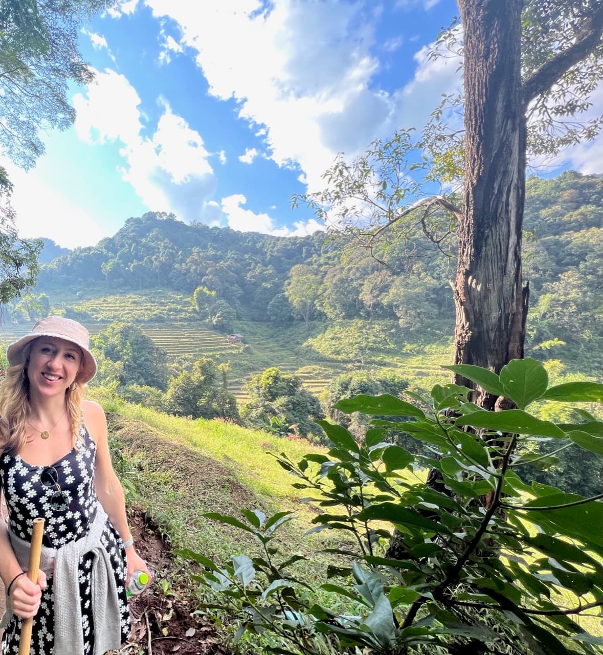 A woman standing in a lush green field