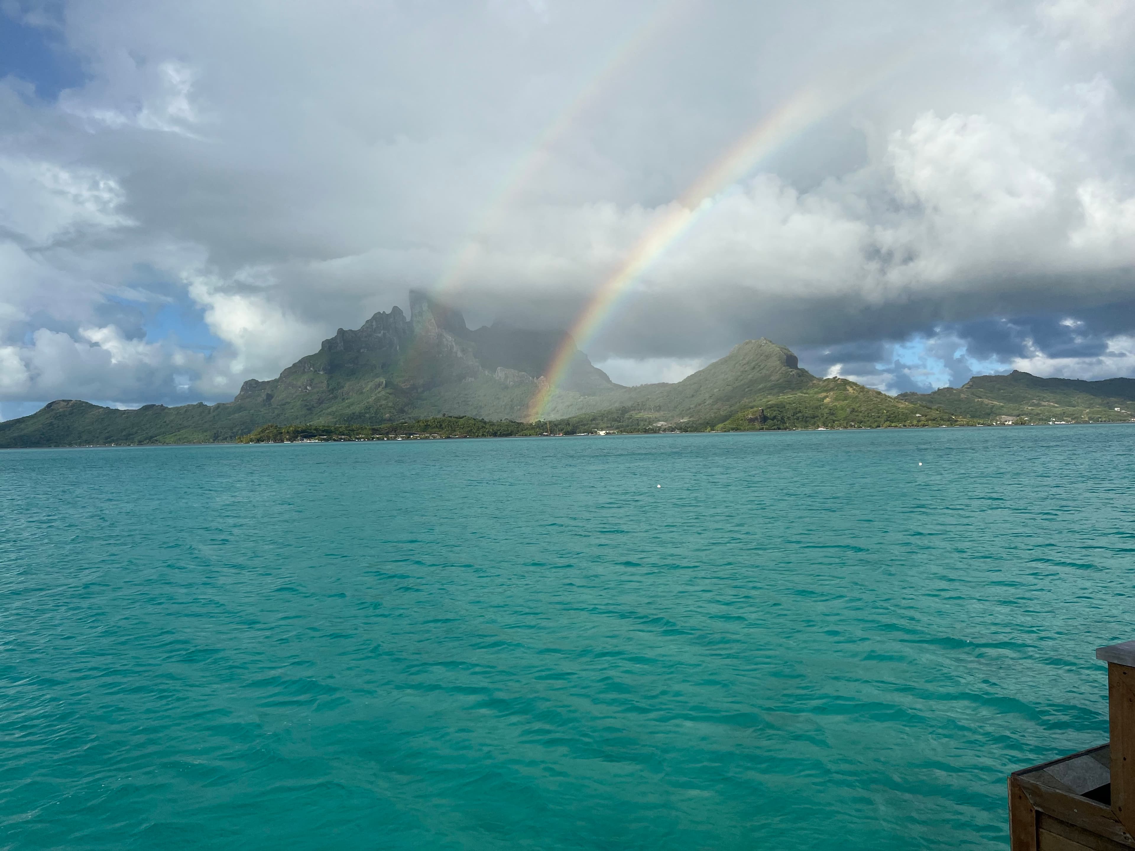 View of the sea, sea stacks, rainbow, and sky