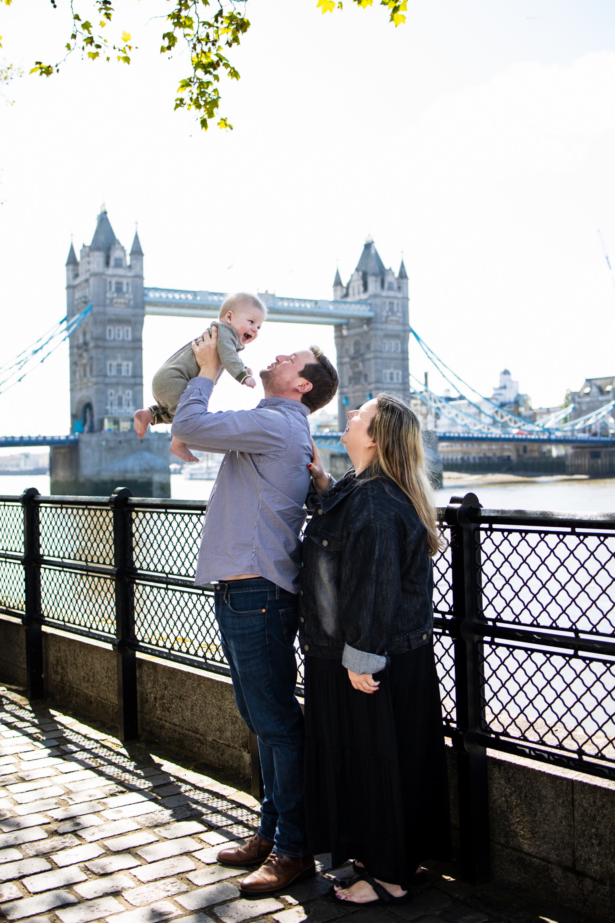Advisor with a man and kid in front of a bridge.