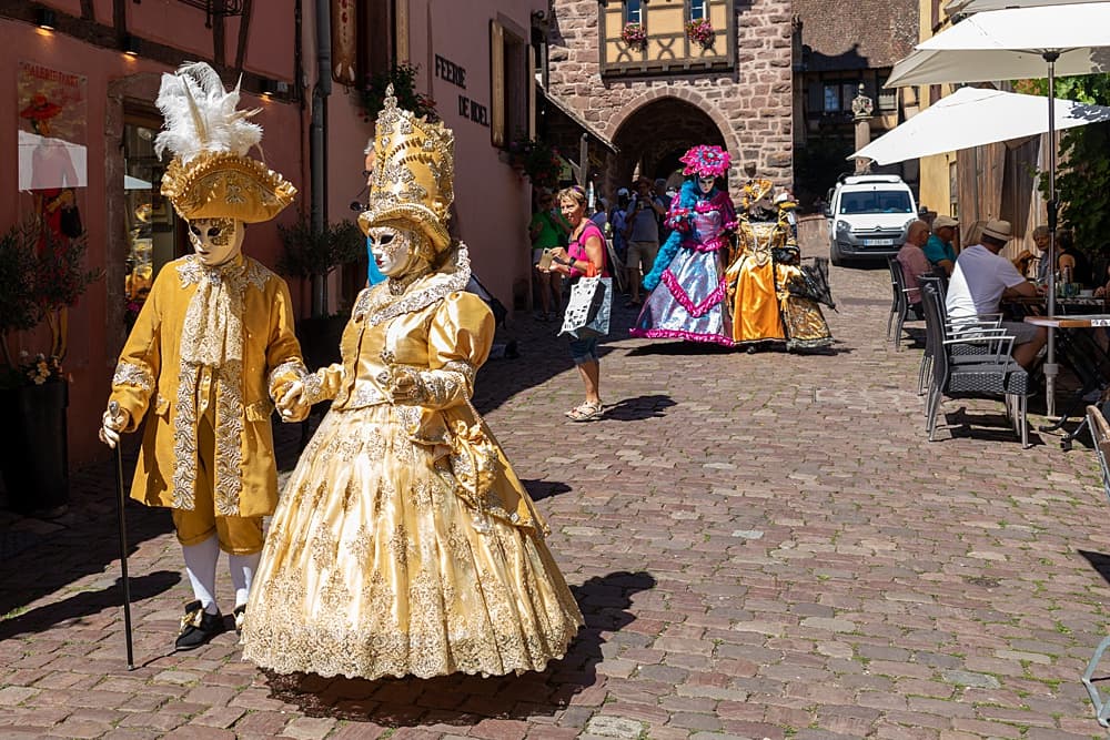 A man and woman in a costume on street.