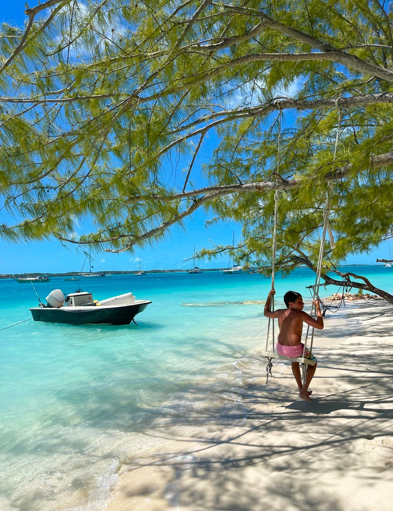 A boy sitting on a swing