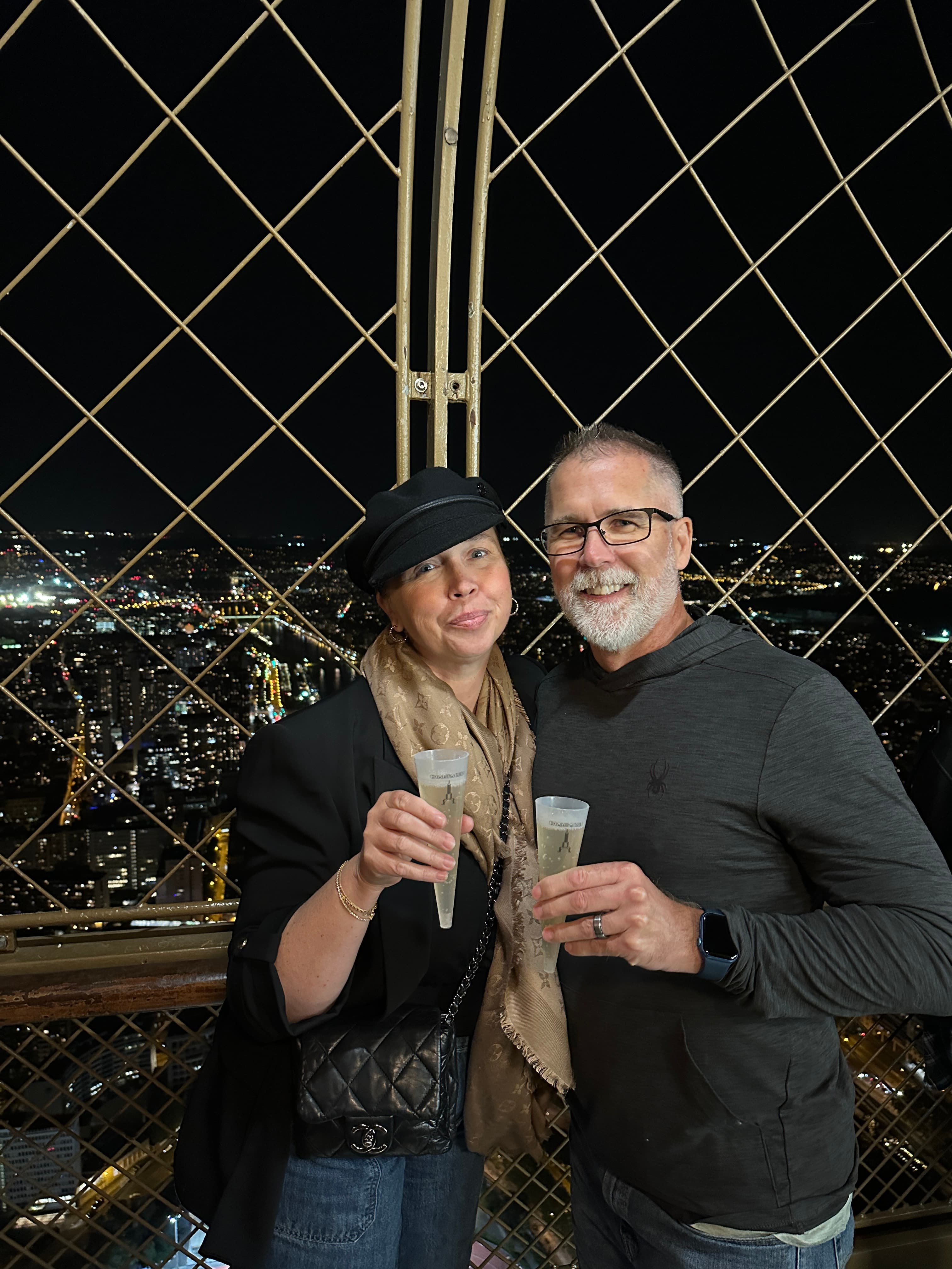 Picture in black dress with drink in hand at night