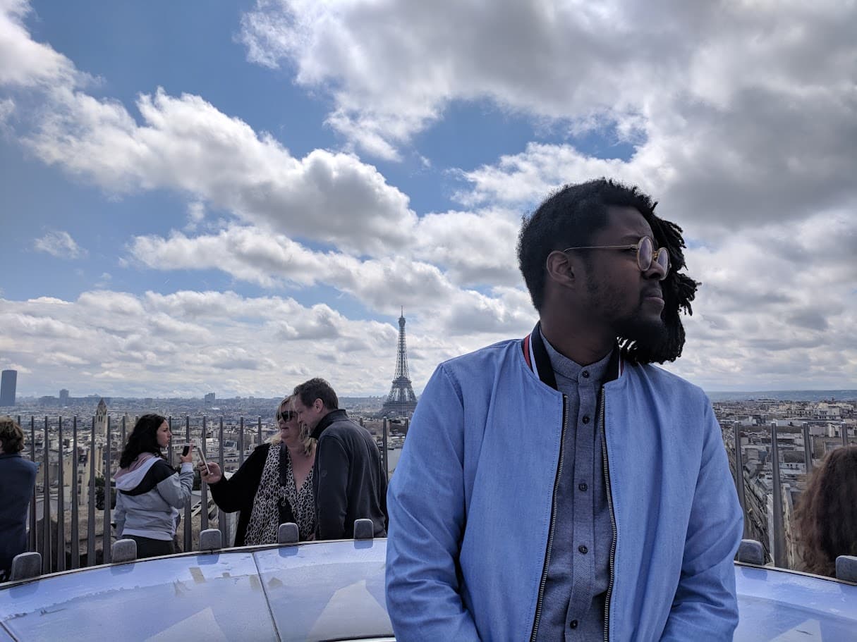 Posing in front of the Eiffel Tower and three people