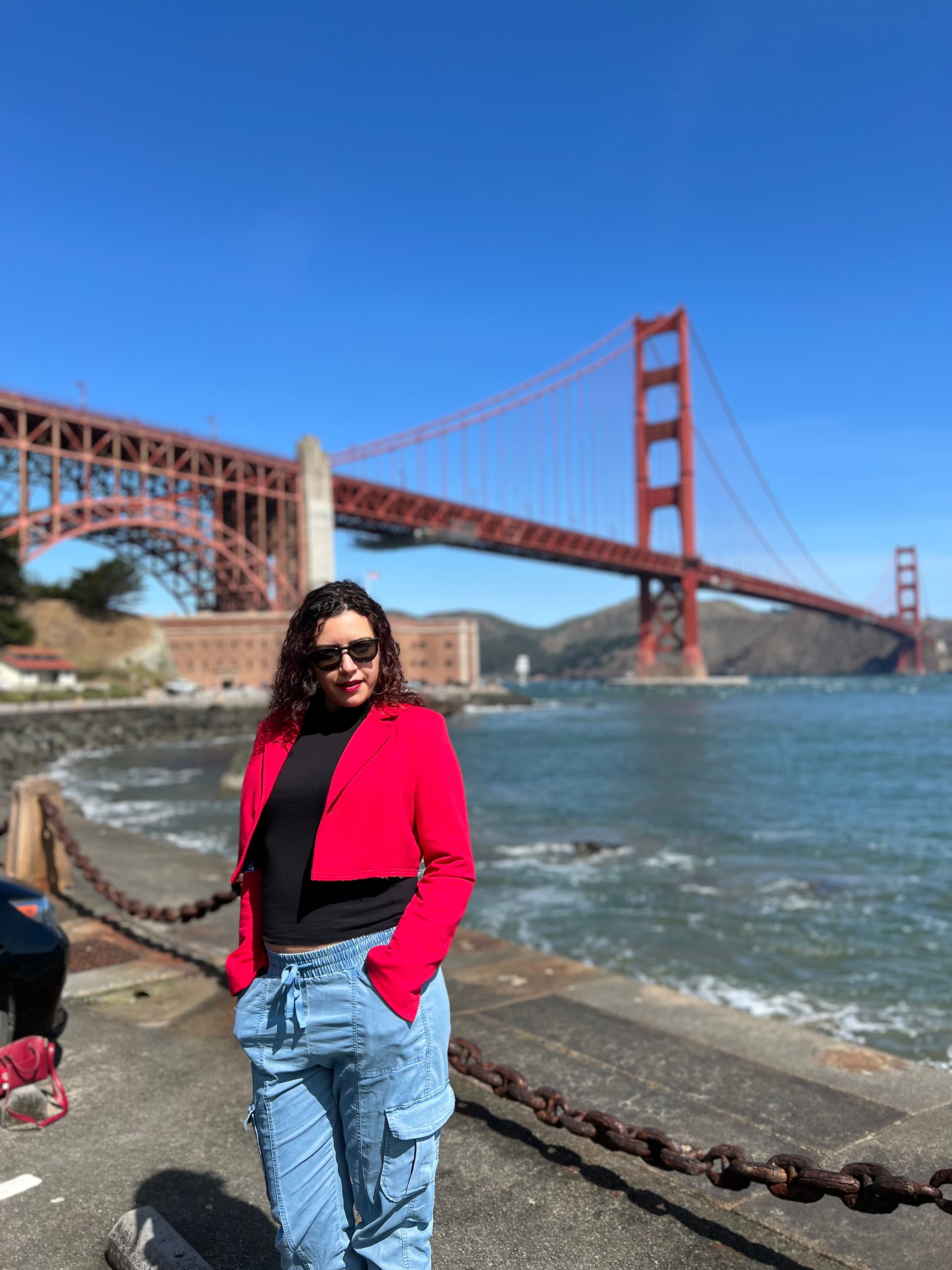 Lauren in red jacket standing near a river
