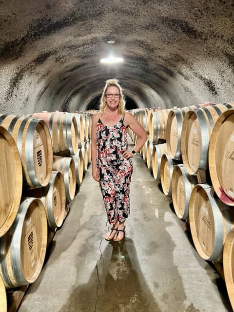Travel advisor Floria posing in a multicolor dress
