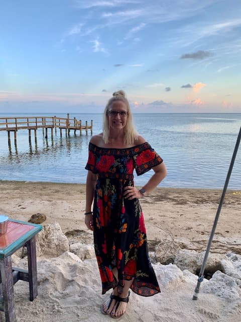 Travel advisor Floria posing in black and red floral dress