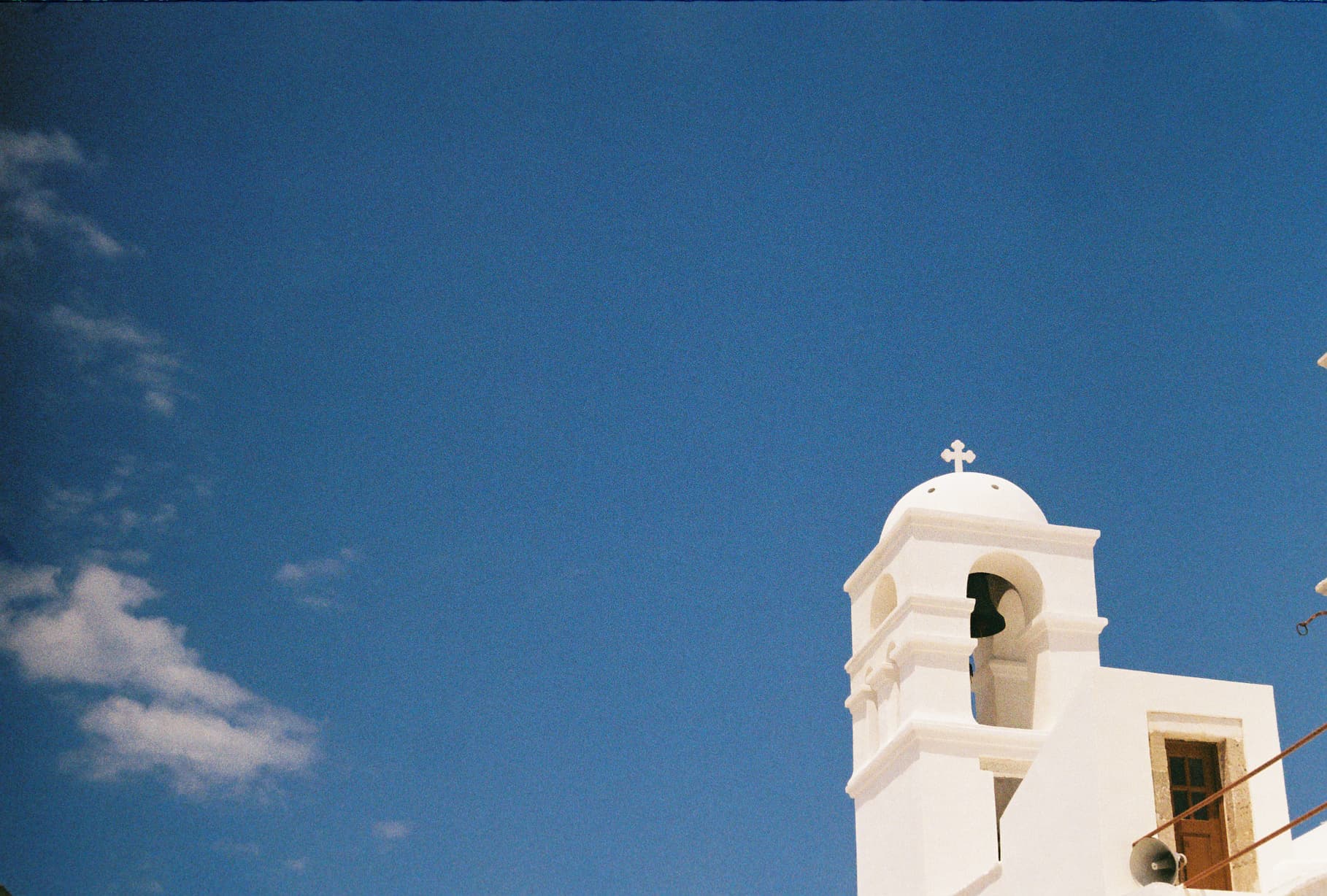 White church building with blue sky.