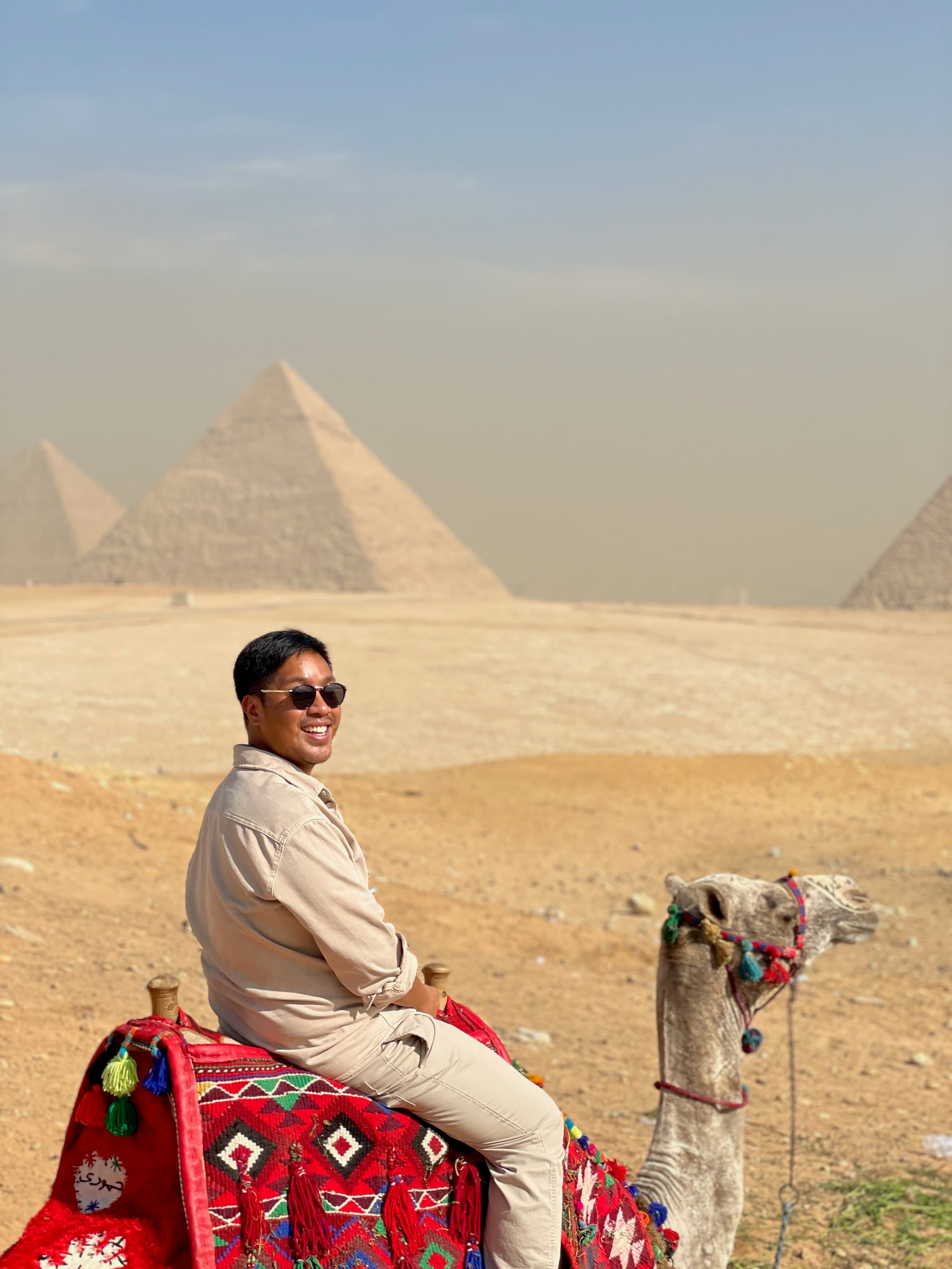 Travel advisor sitting on camel