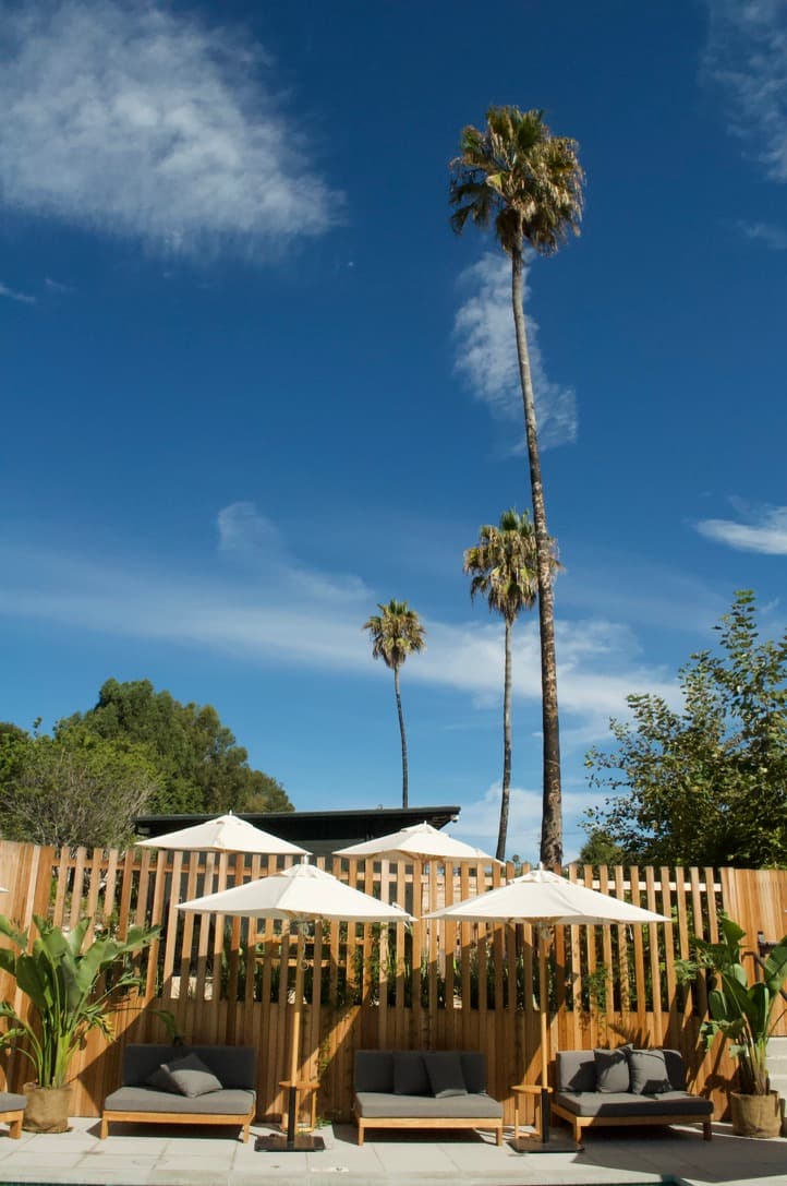 Picture of sunloungers and straw umbrella.