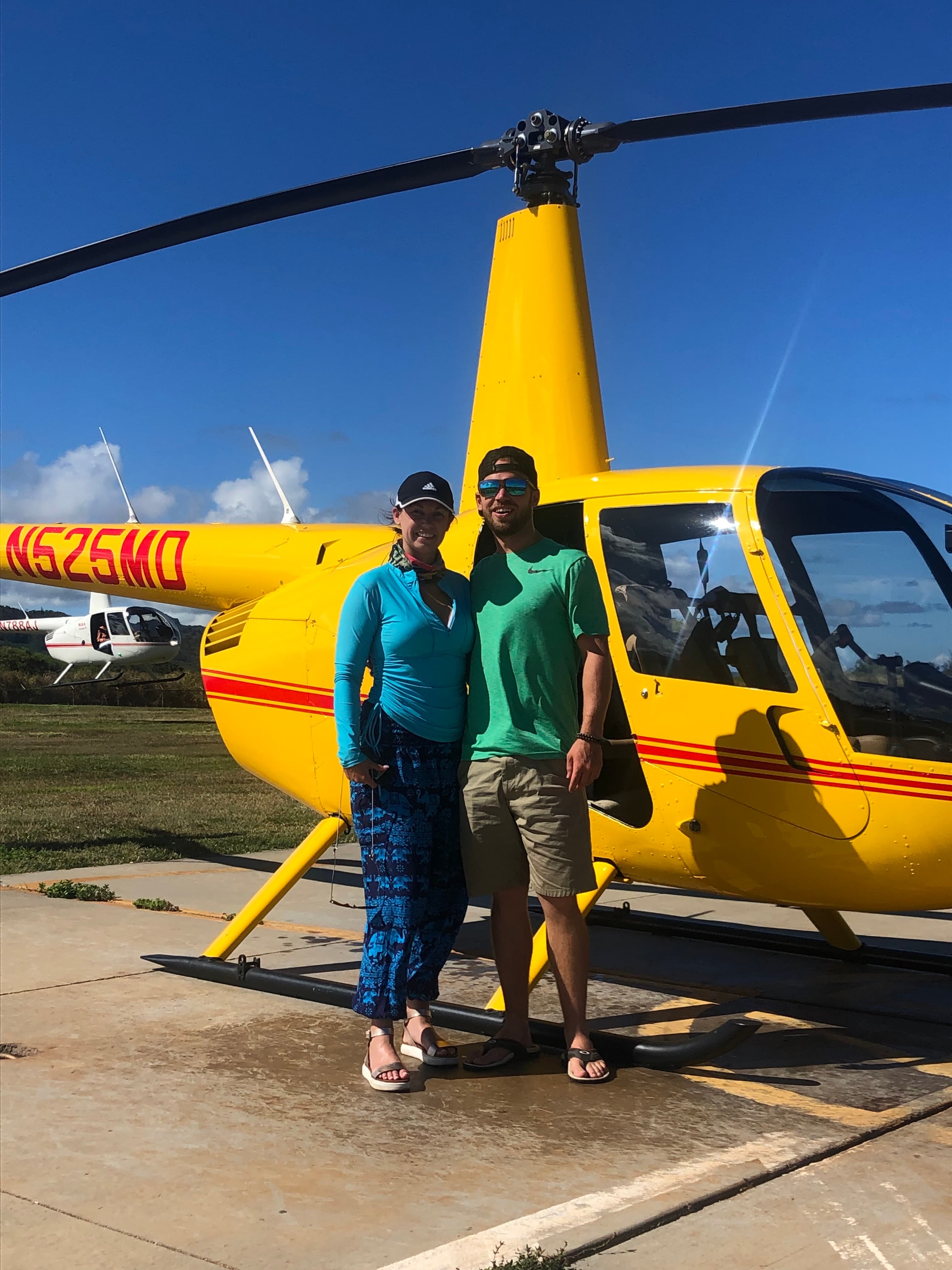 Posing for a picture with a yellow helicopter